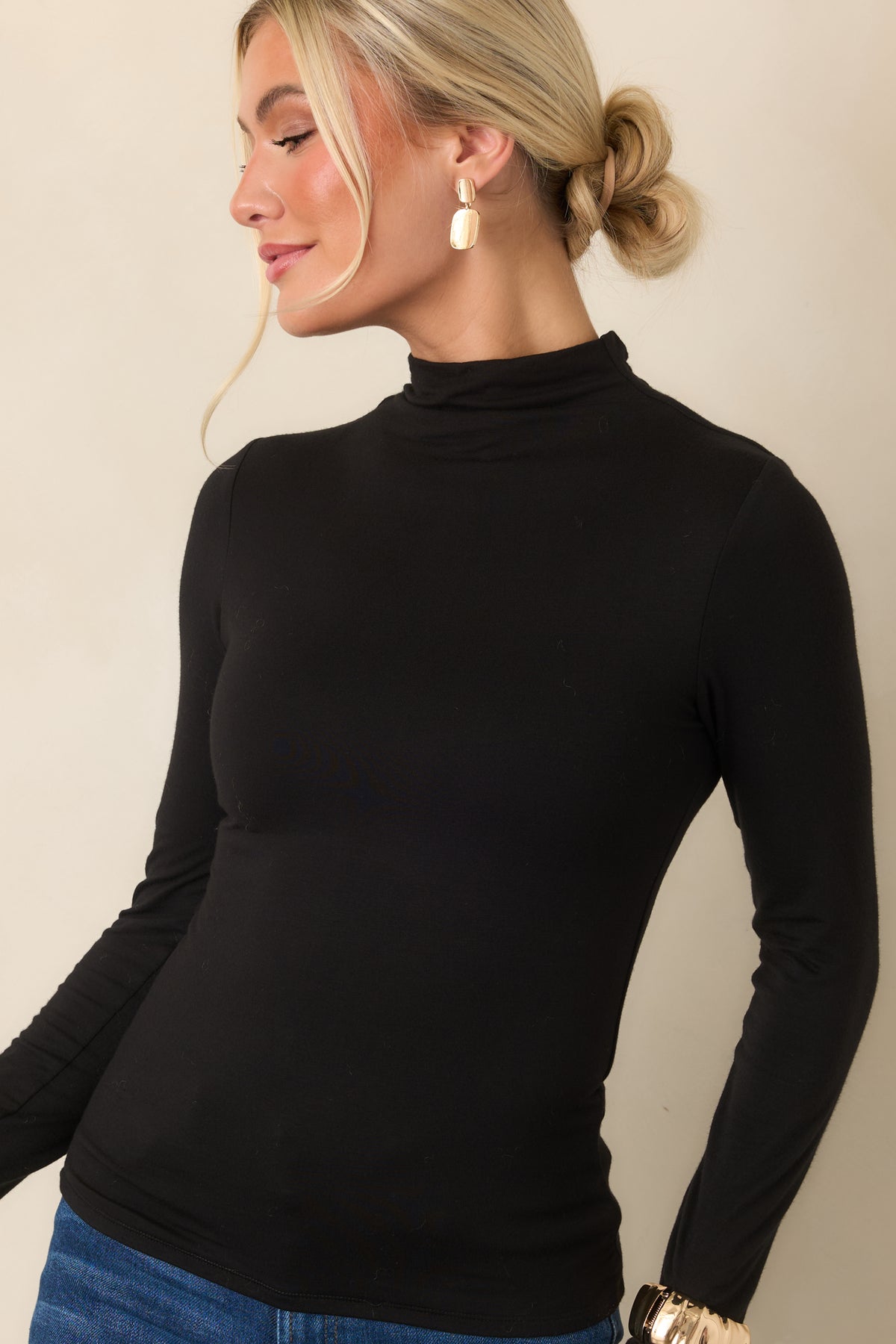 Stretch knit top featuring a smooth finish, close-fitting silhouette, and clean long sleeves.
