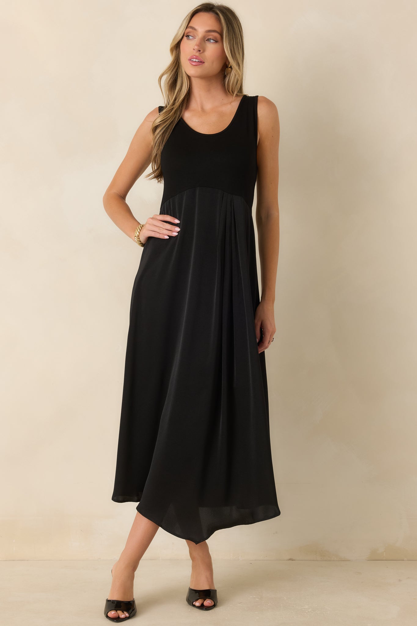 Black midi dress with a comfortable stretch-knit top and fluid satin skirt designed for graceful movement.