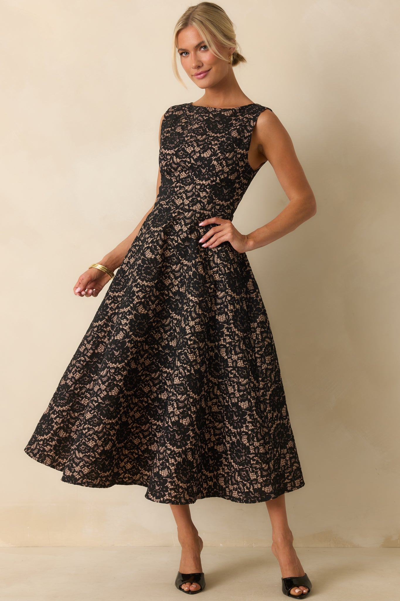 Classic black and tan lace dress with an A-line cut and refined bateau neckline.