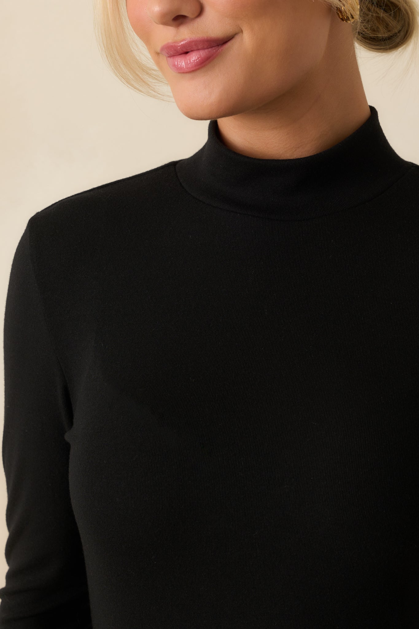 Fabric texture of the black top with its smooth, lightweight finish.
