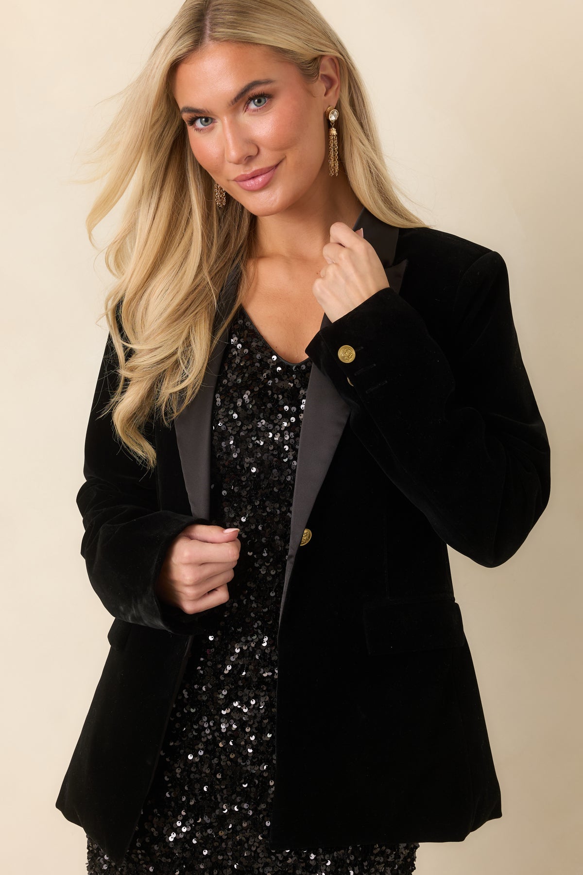 Long sleeves and smooth velvet fabric define the classic black blazer silhouette.