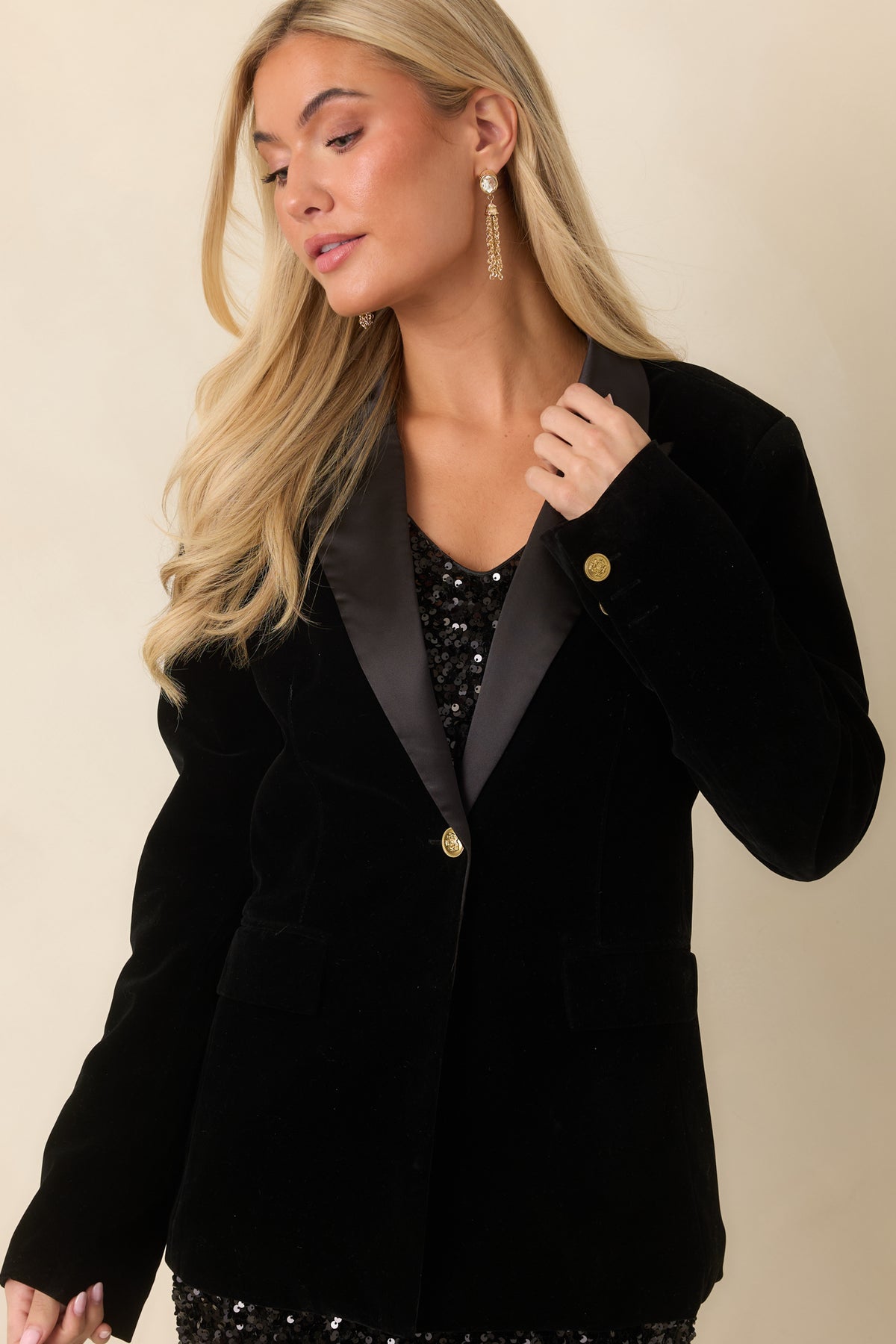 Satin lapels frame the front opening of the fully lined black velvet blazer.