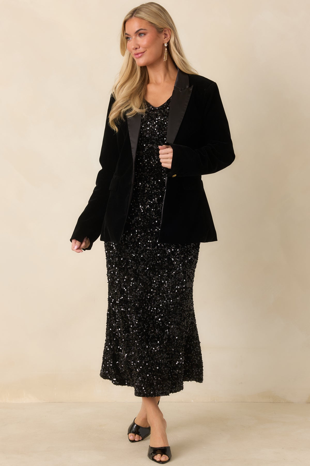 Tailored black velvet blazer featuring long sleeves, a single gold front button, and a structured silhouette.