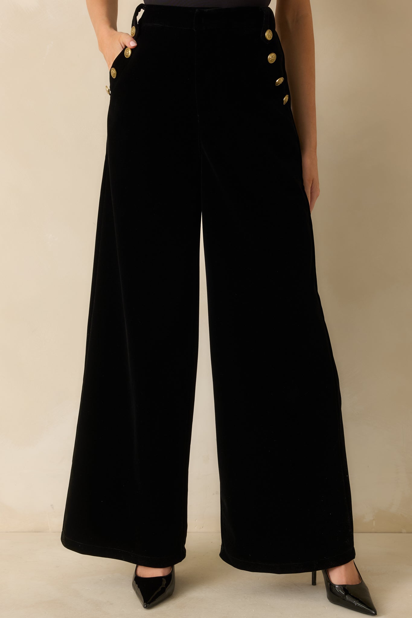 Black velvet pants with a high-rise waist and wide-leg silhouette for an elegant finish.