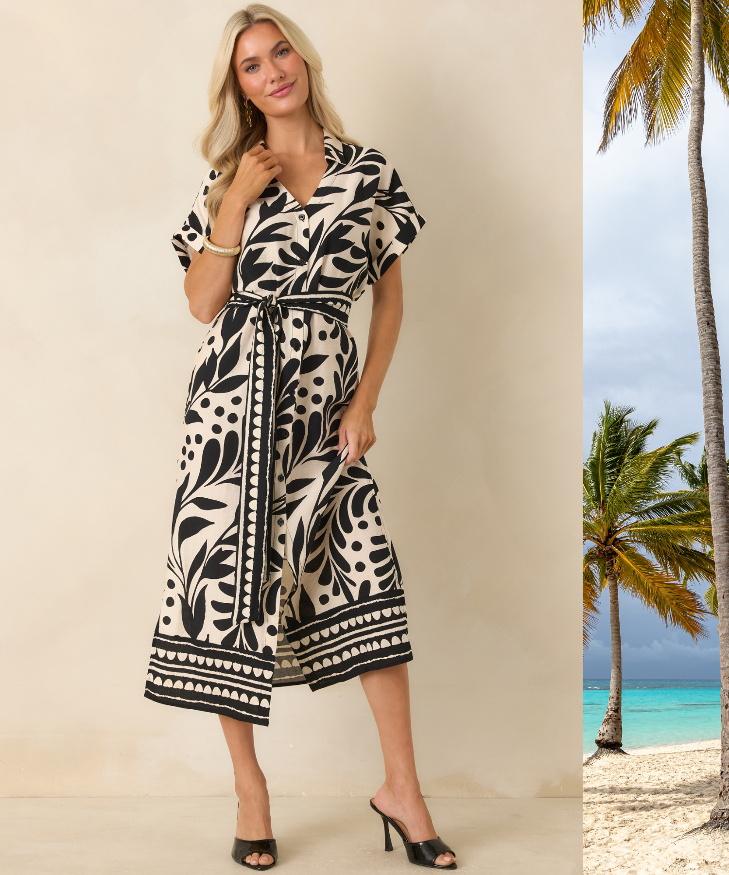 Woman wearing a black and natural botanical print midi dress against a beige backdrop with a beach scene peeking in. 