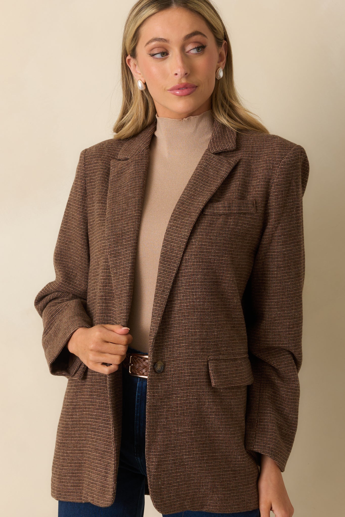 Cropped front view highlighting the notched lapel collar and button cuff details.
