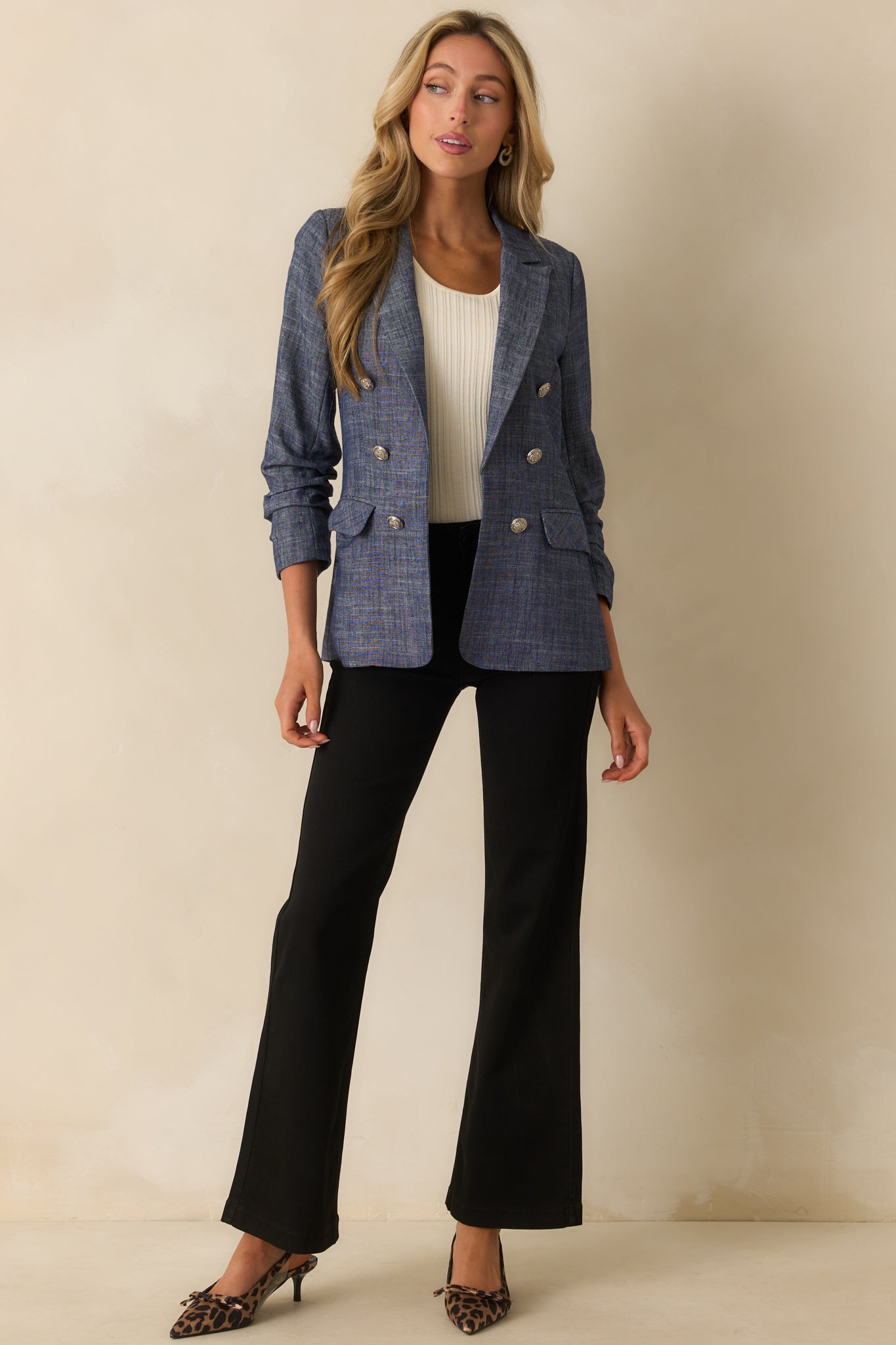 A full front view of the blazer with a notched lapel collar and ruched 3/4 length sleeves.