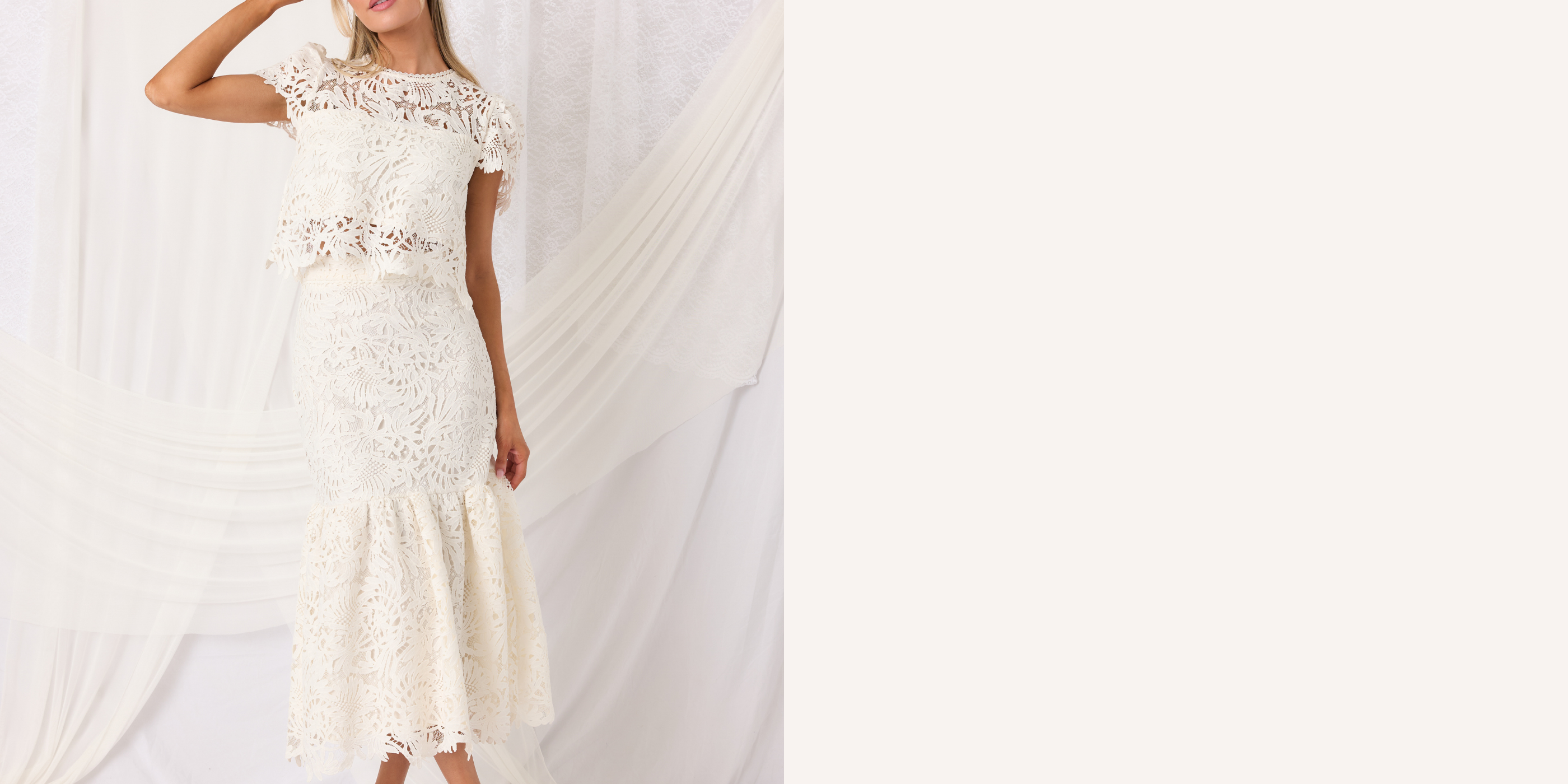 Ivory lace two-piece set with a flowing train on a white background