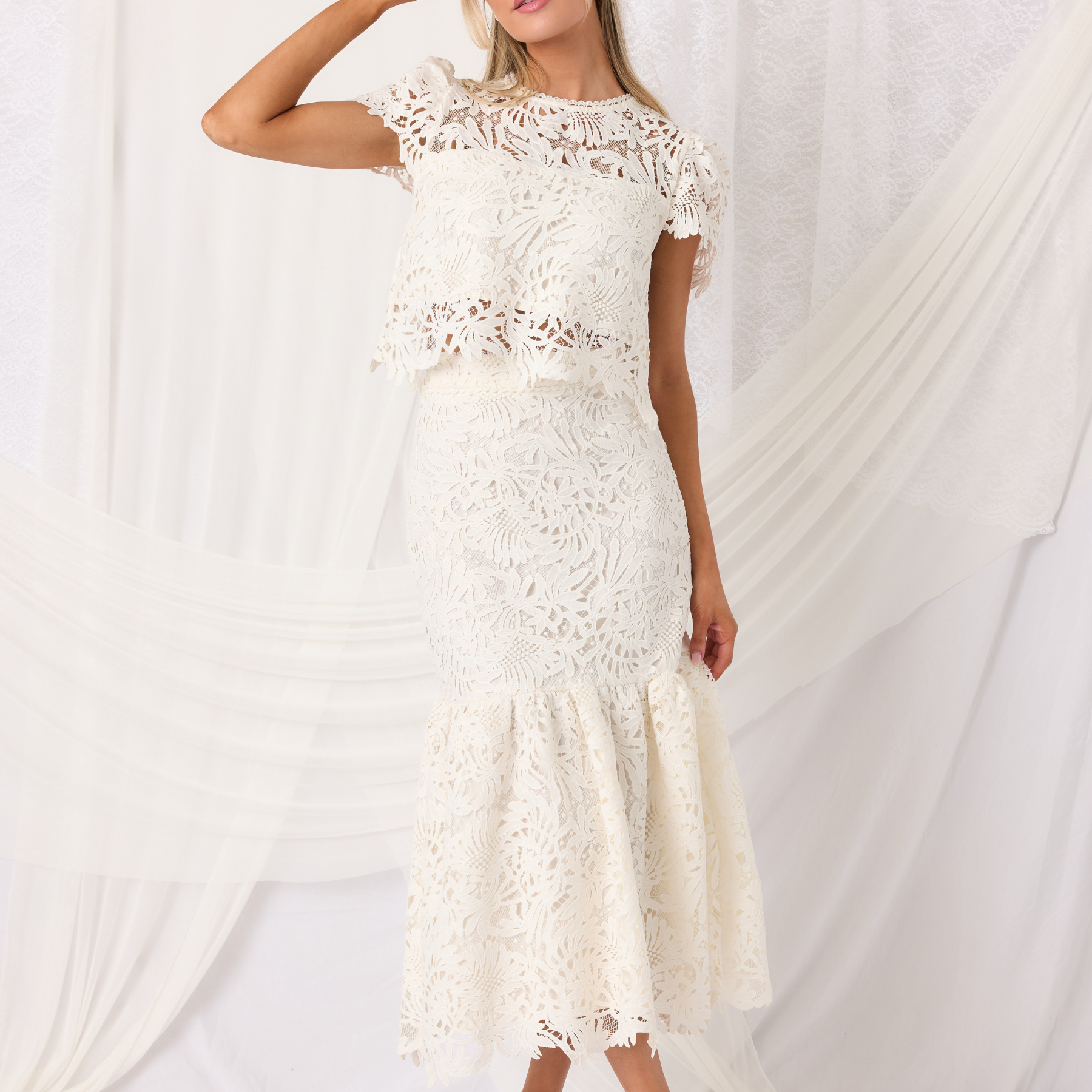 Ivory lace two-piece set on a white background.