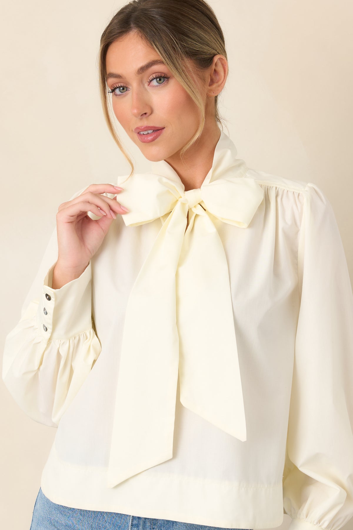 Softly gathered shoulders flow into long balloon sleeves, creating an elegant, dimensional finish.