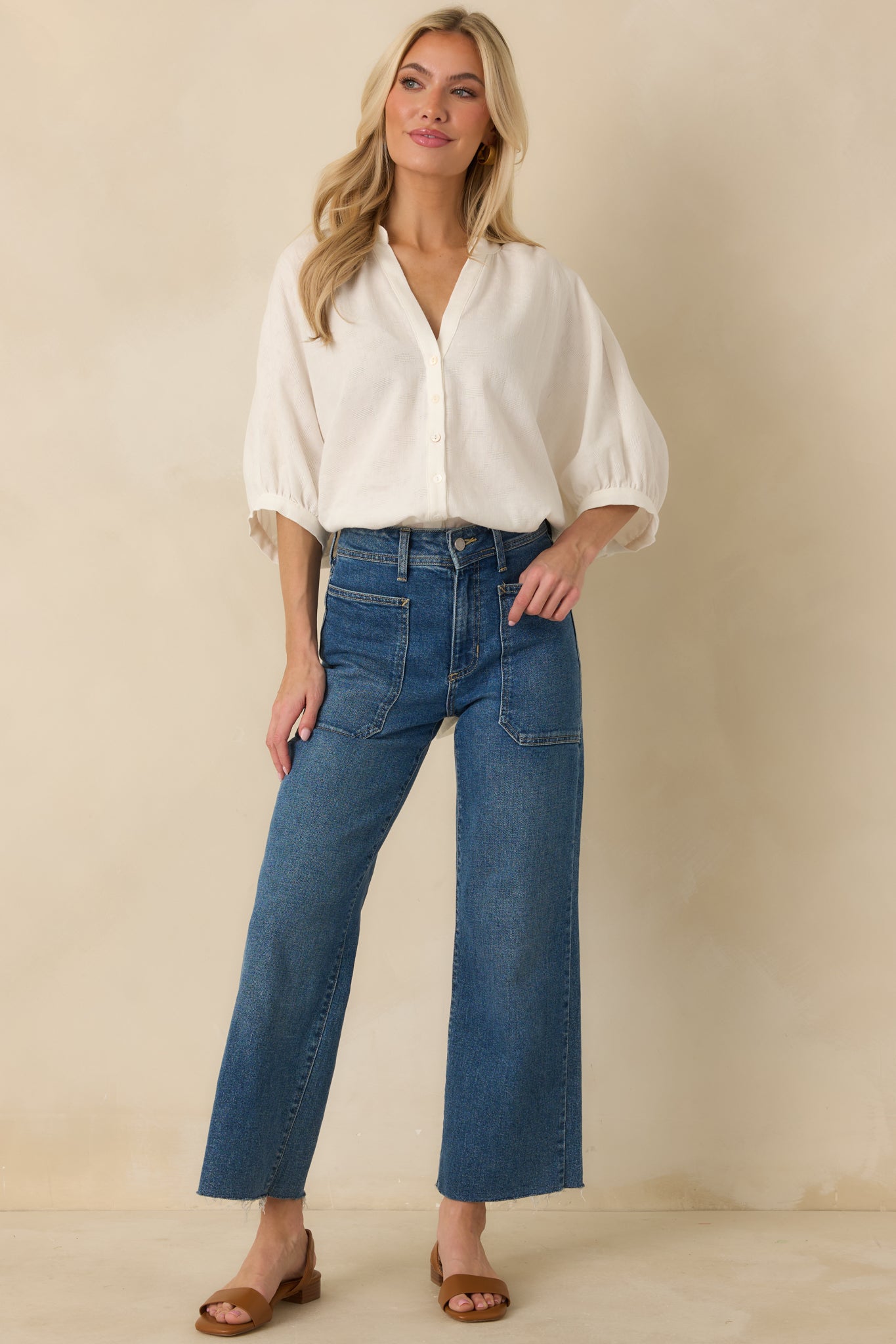 Breezy blouse with front button placket, elasticized 3/4 sleeves, and flowy hemline.