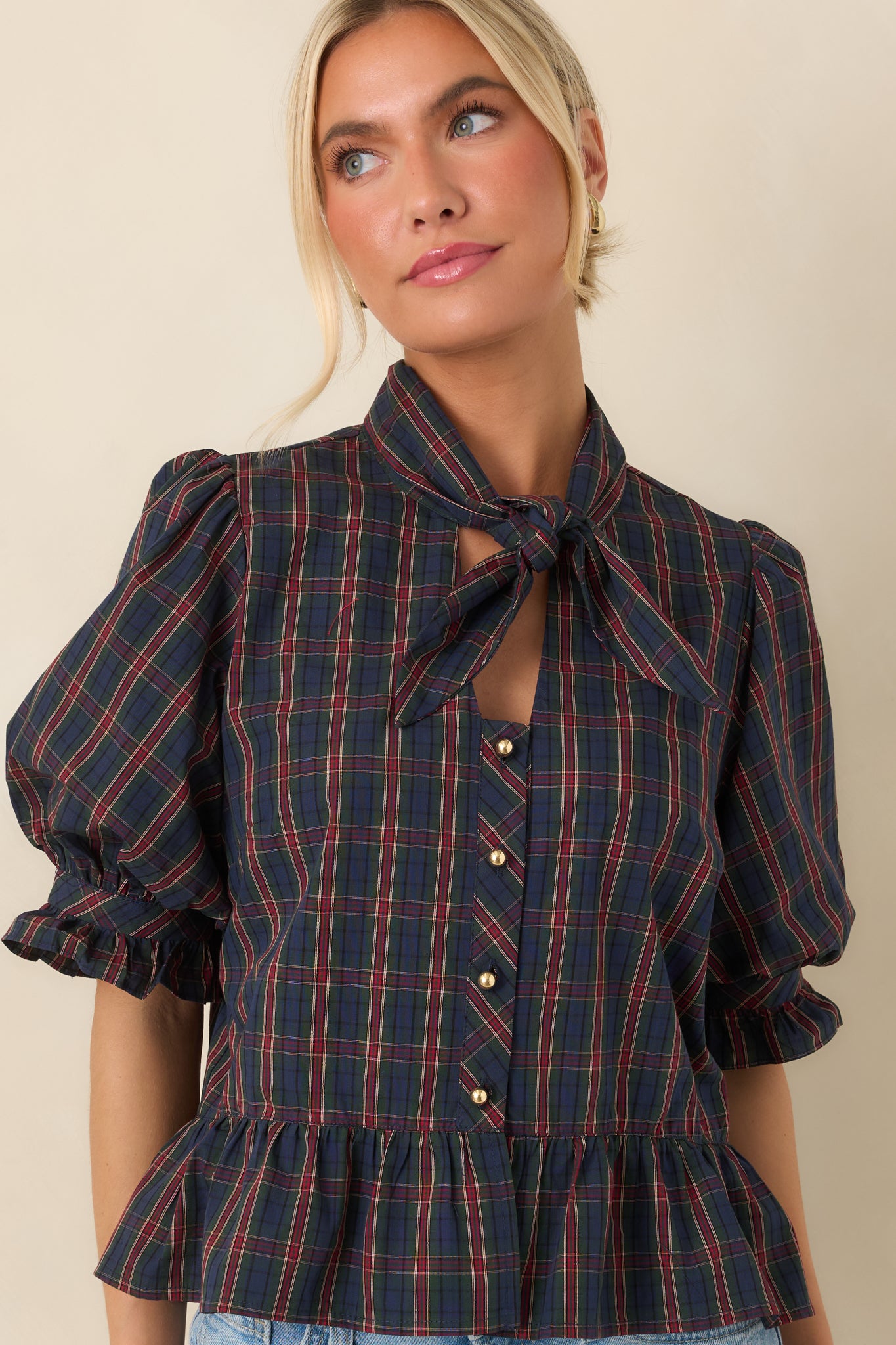 The front of this blouse highlights the self-tie neckline and polished gold-tone button details.