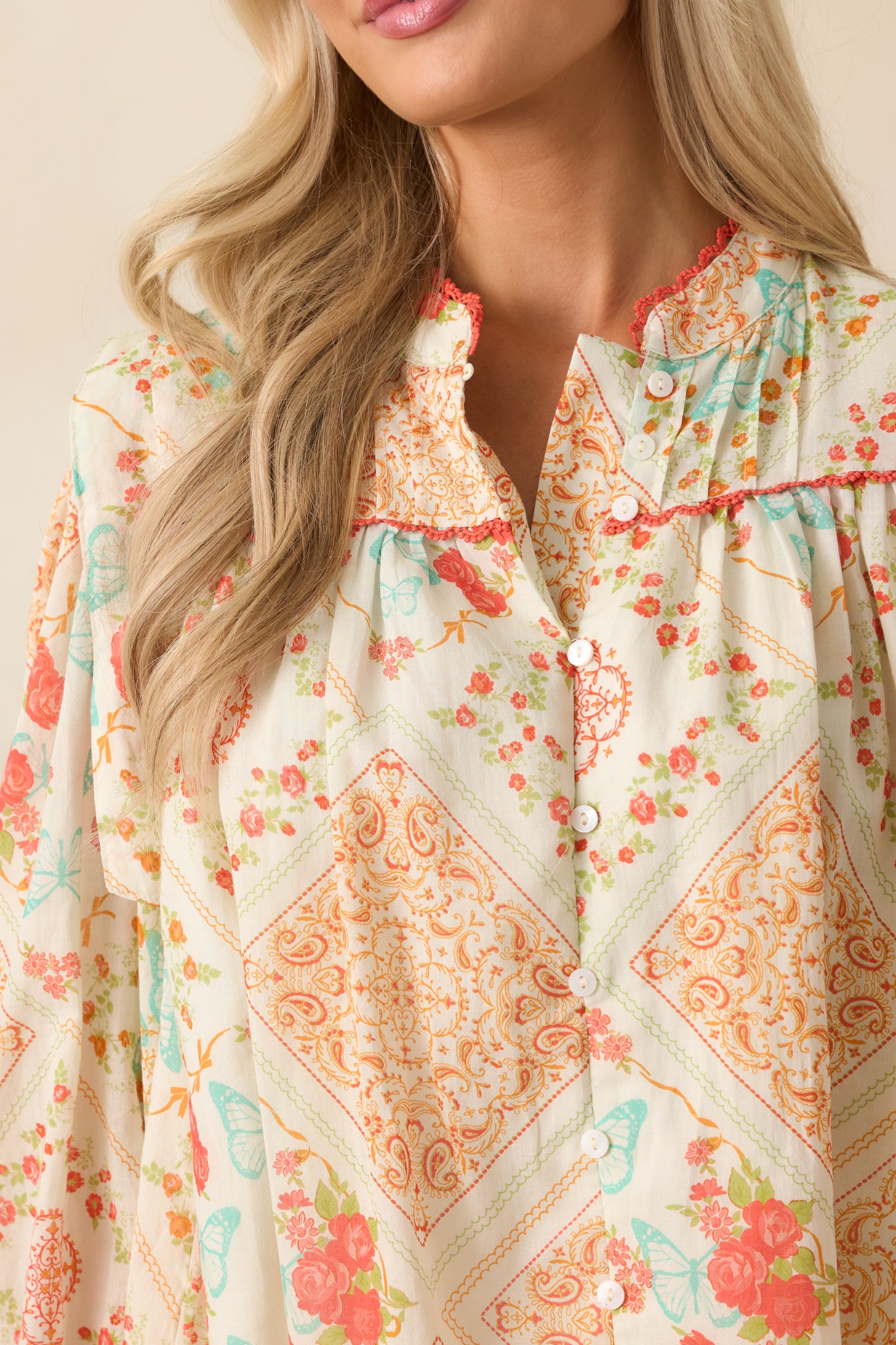 A zoomed-in view of the blouse showing the partially open button front and the intricacy of the fabric pattern.