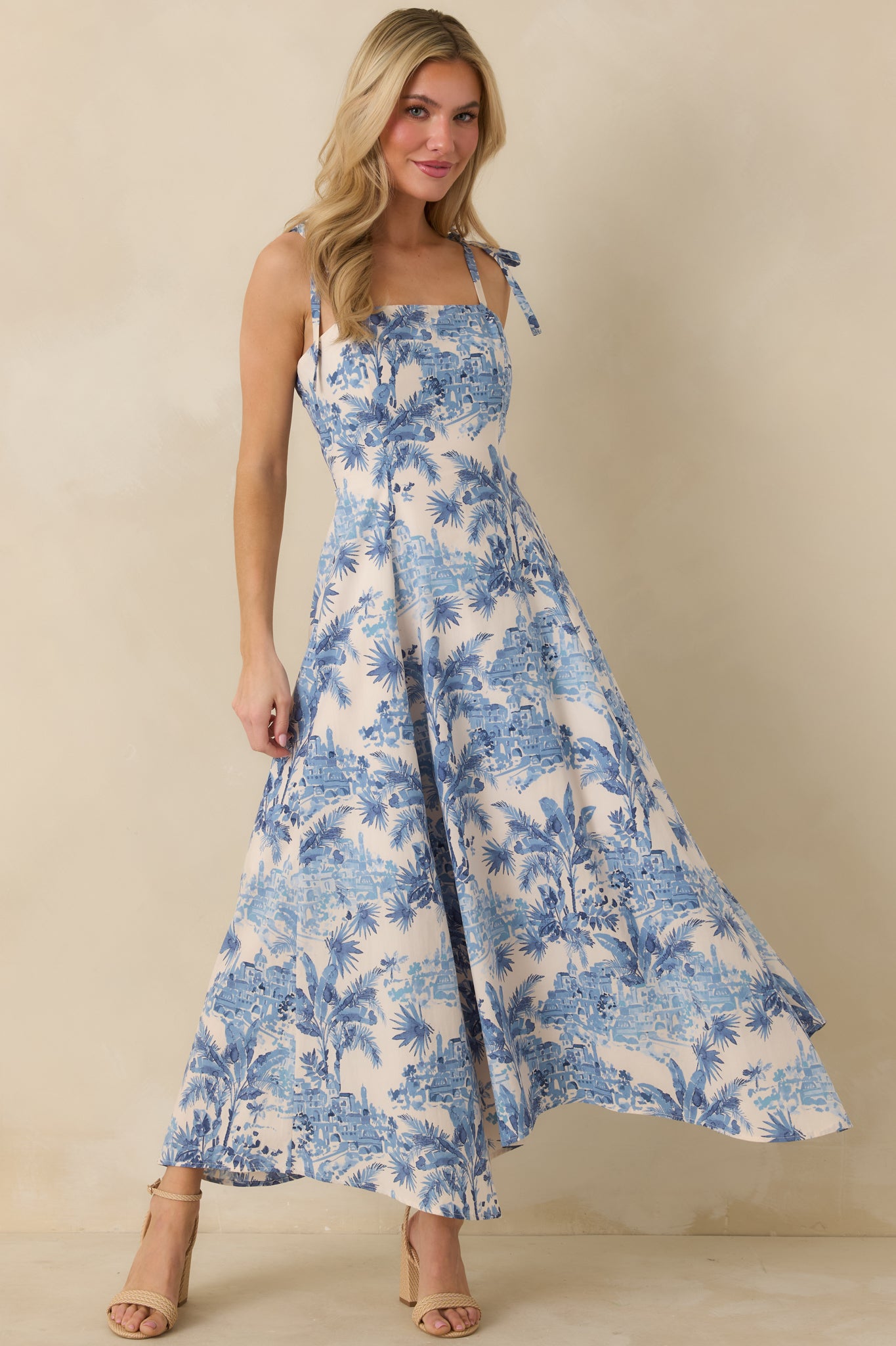 Blue and ivory maxi dress with square neckline and adjustable tie straps.