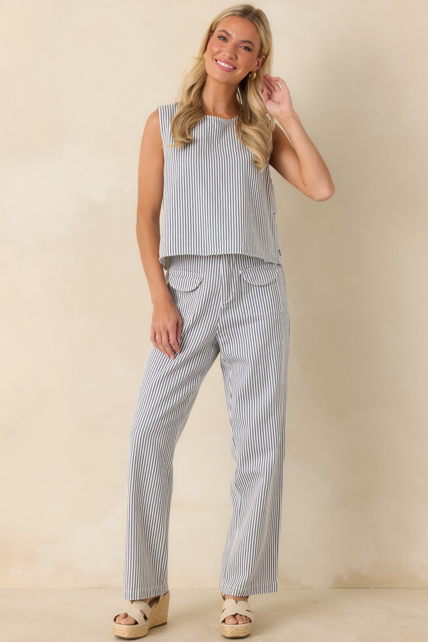 Blue and ivory striped top featuring a boat neckline, relaxed fit, and clean horizontal stripe pattern.