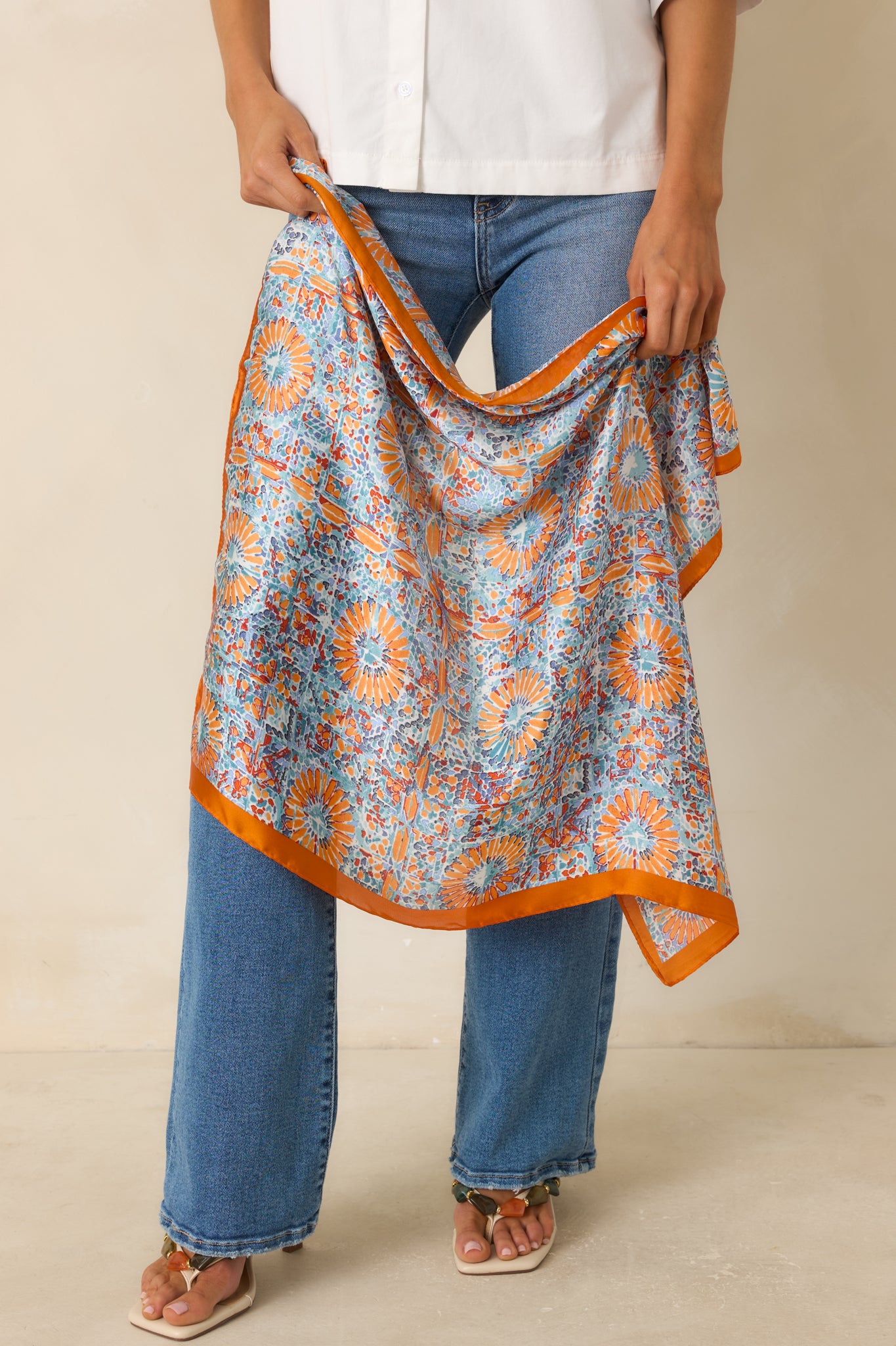 Mosaic print scarf showcasing a lightweight woven fabric, vibrant blue and orange tones, and a soft square silhouette.