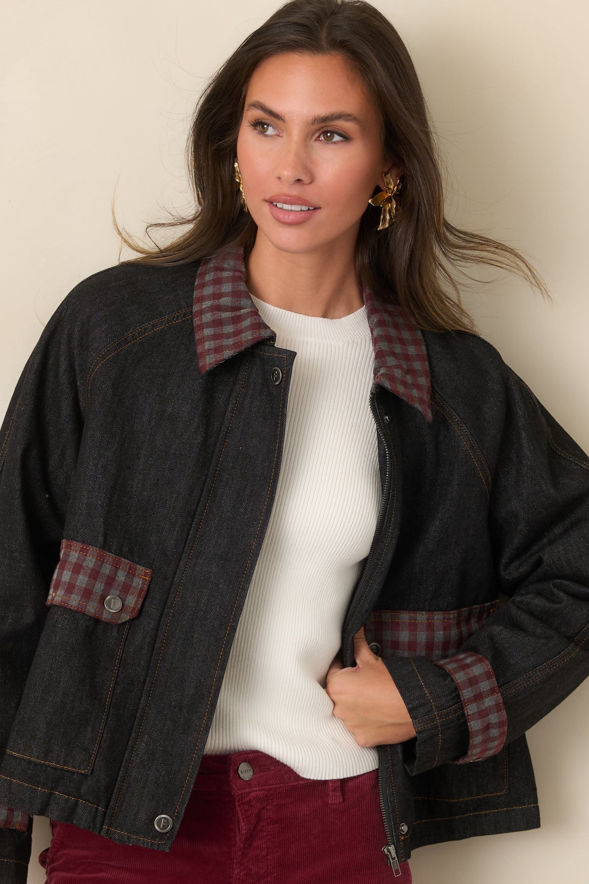 Blue denim jacket featuring a gingham-trimmed collar, oversized pockets, and relaxed raglan sleeves.