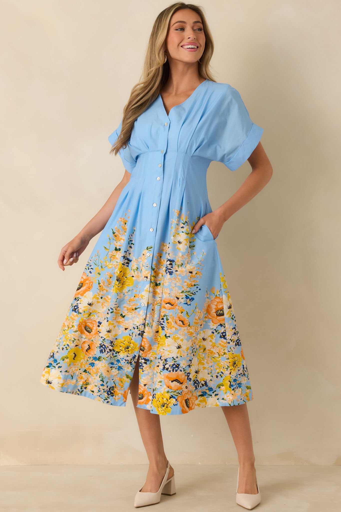 Blue floral border midi dress with V-neckline, flutter sleeves, and comfortable flowy skirt for easy movement.