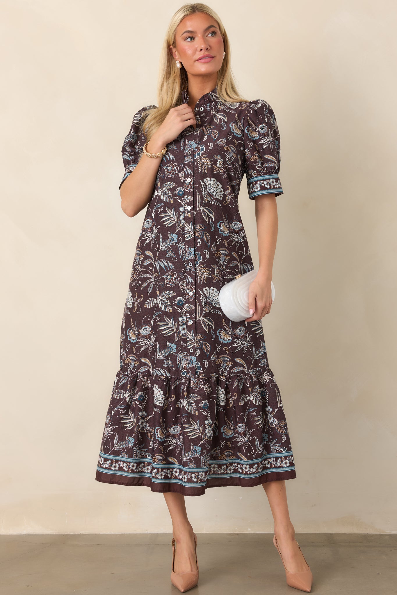 Floral midi shirt dress displaying a graceful button-front design, muted blue and ivory accents, and decorative detailing along the hem.