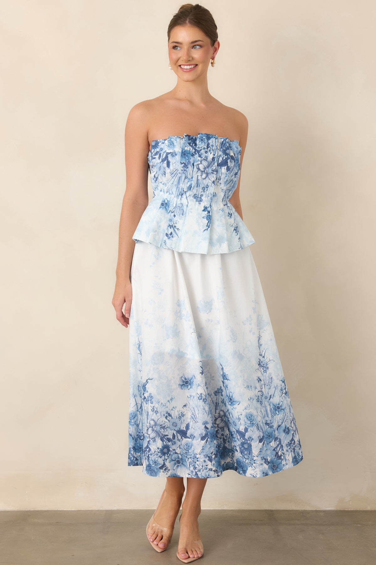 Blue floral cotton midi dress highlighting the pleated bodice and softly gathered waist.