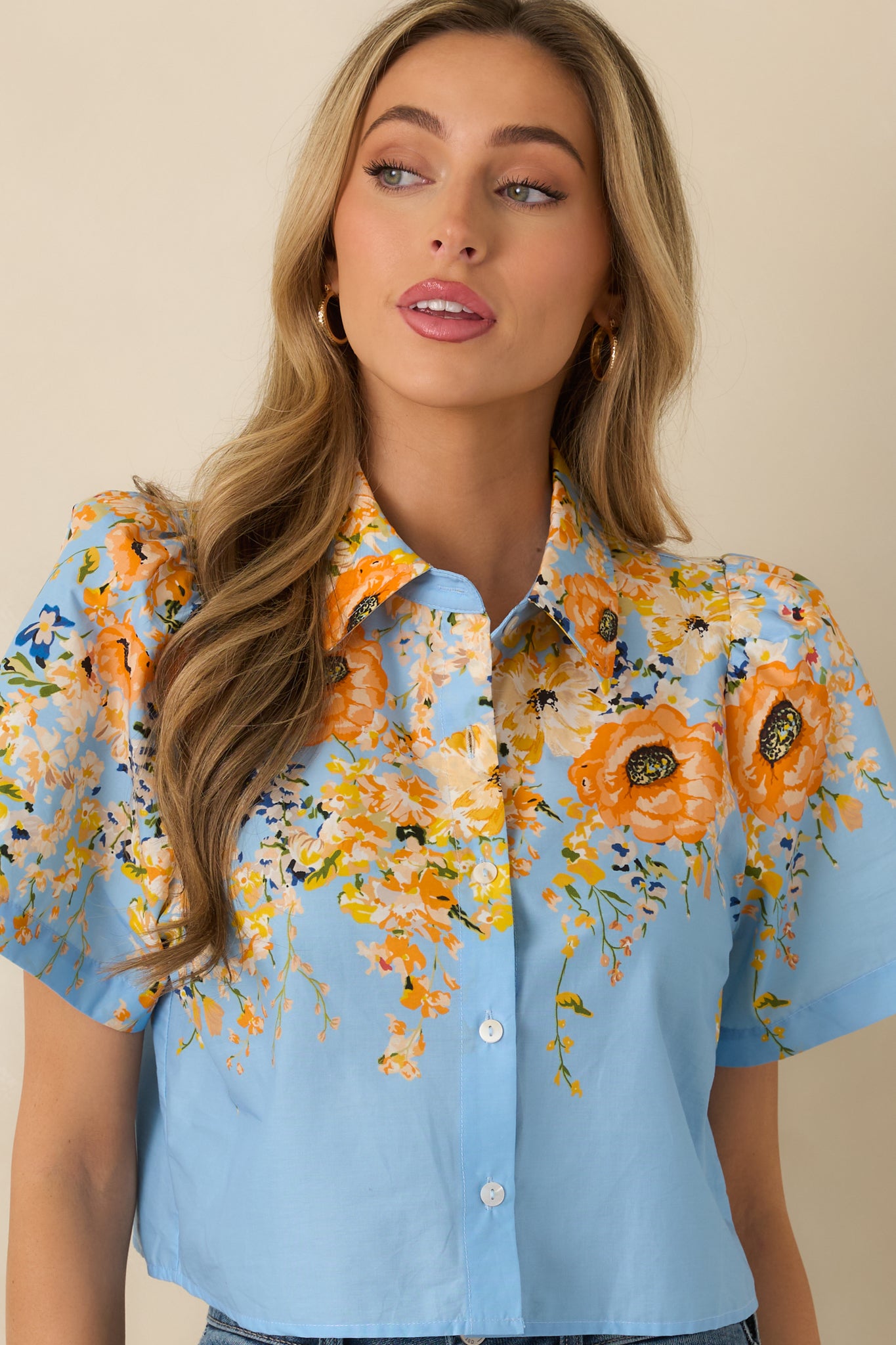 Blue floral cotton top highlighting the collared neckline and button-down front.