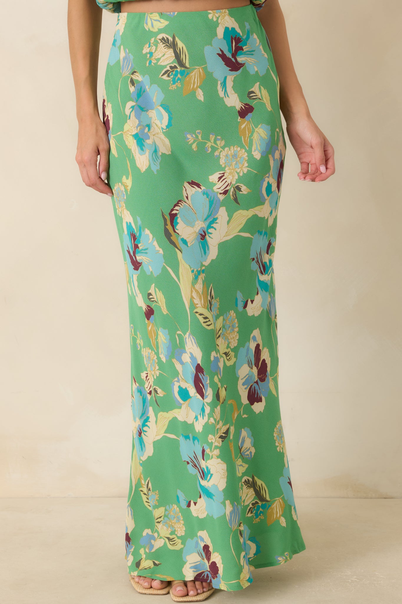 Oversized blue floral print stands out against the bright green backdrop of this flowing skirt.