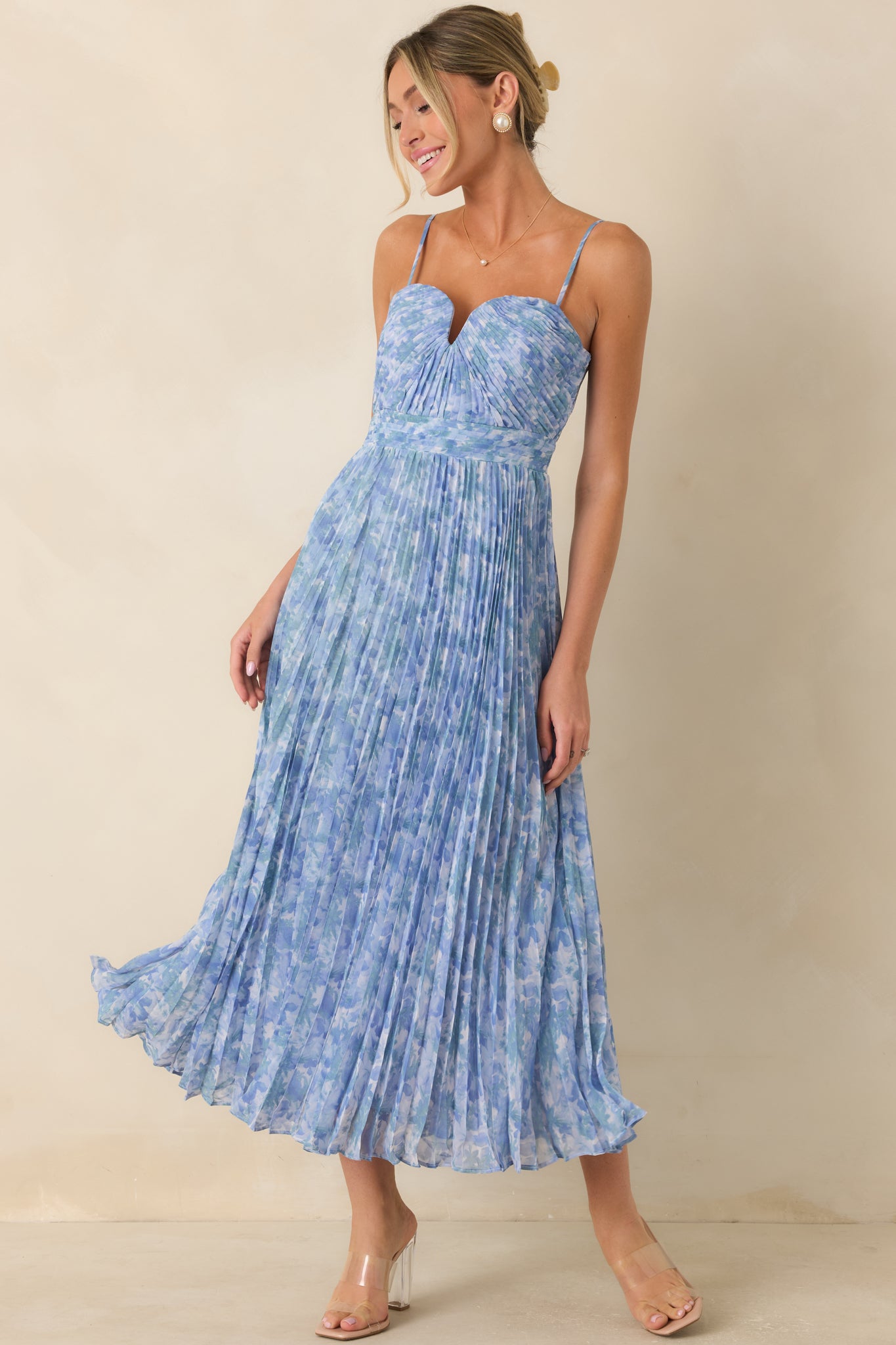 Blue watercolor floral maxi dress featuring a sweetheart neckline, adjustable spaghetti straps, and a flowing pleated skirt.