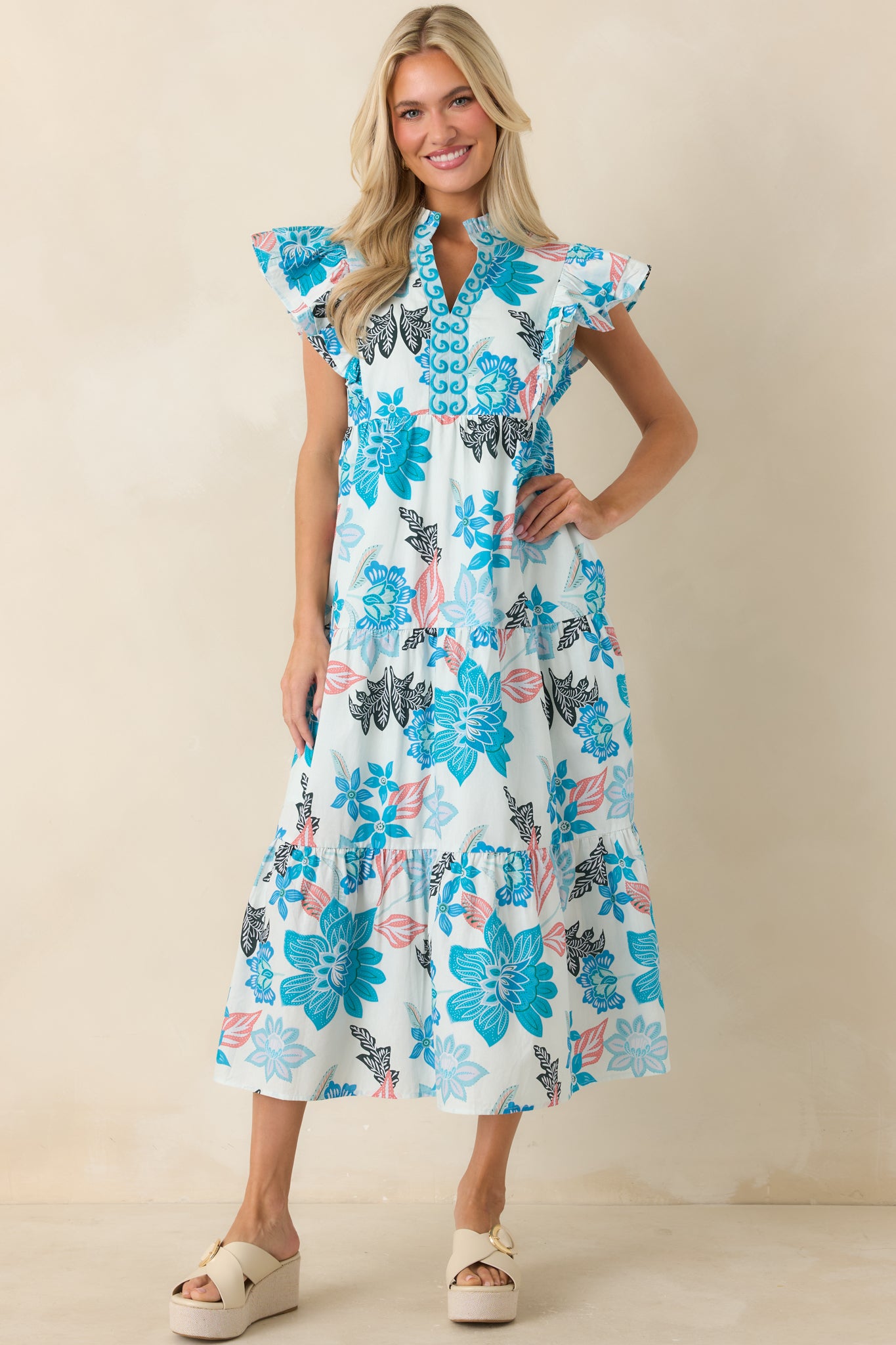Blue floral midi dress with a relaxed fit, embroidered accents, and a lightweight tiered design.