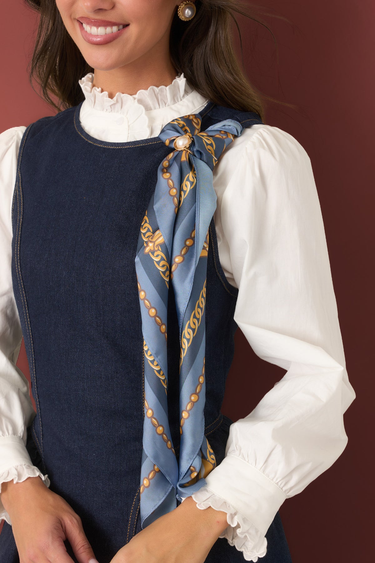 Scarf featuring light and slate blue tones with ornate gold chain motifs and decorative medallion details.