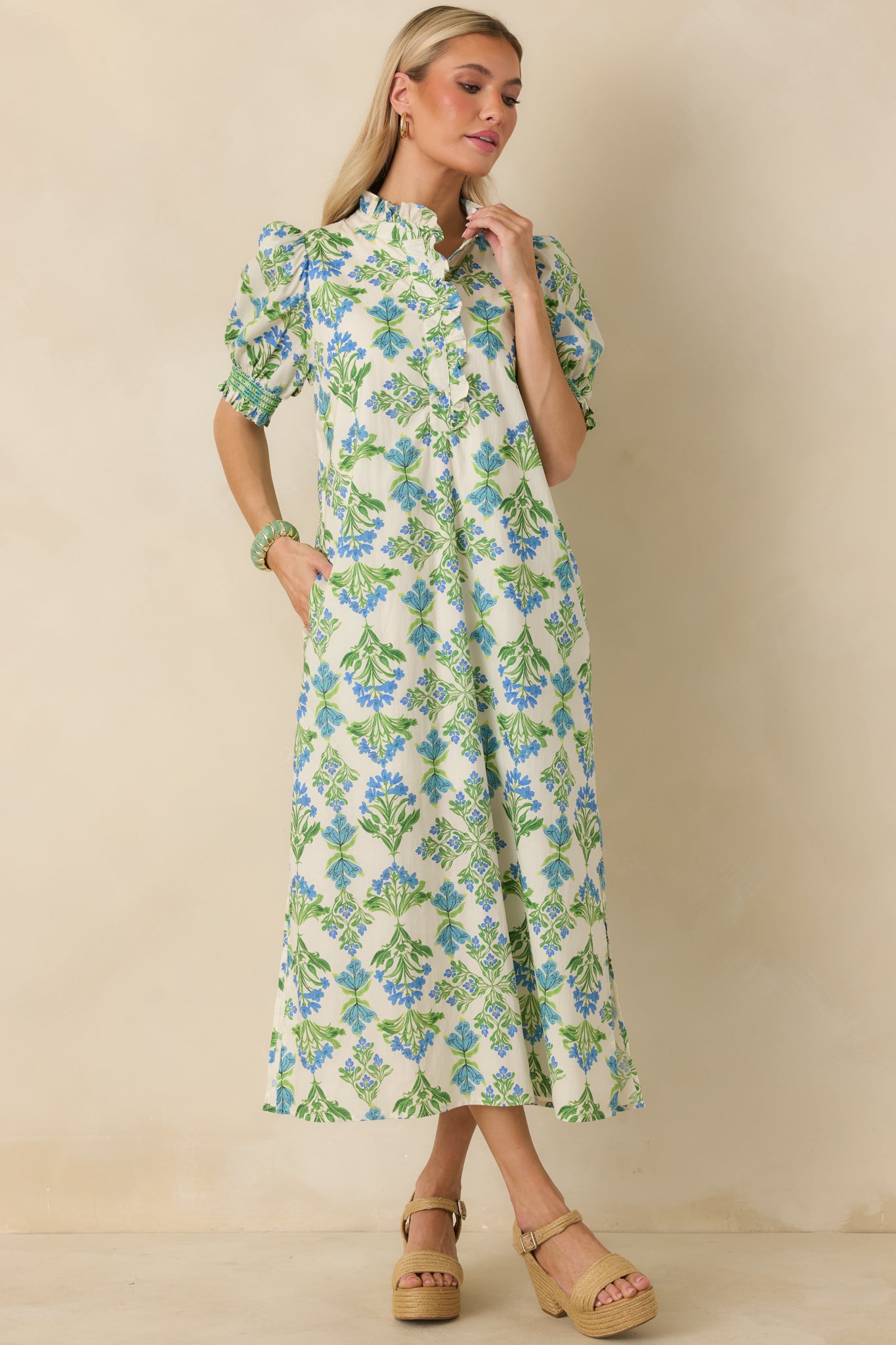 Blue and green floral maxi dress emphasizing the clean lines of the straight fit and the flowing maxi-length hem.