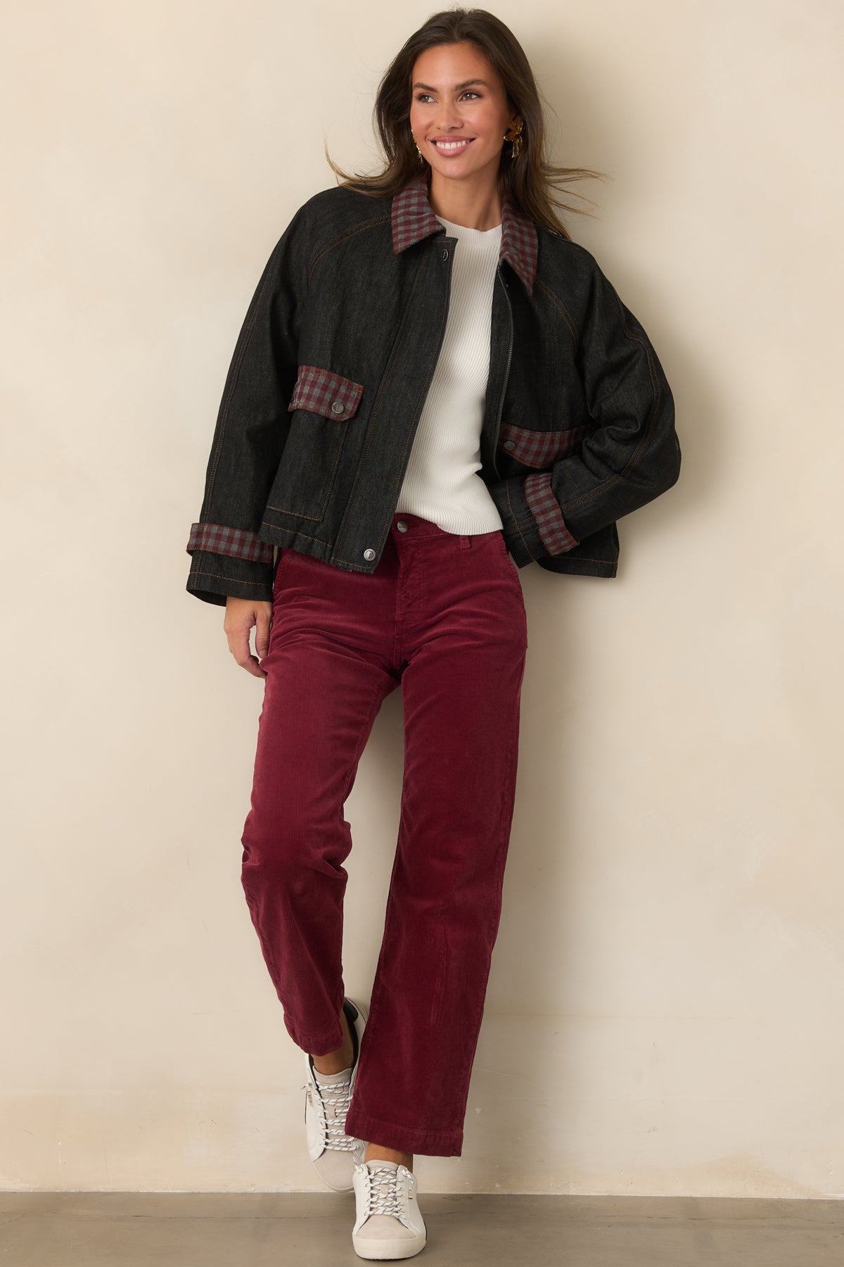 Deep blue jacket showcasing burgundy and grey gingham pocket flaps, contrast stitching, and raglan sleeves.