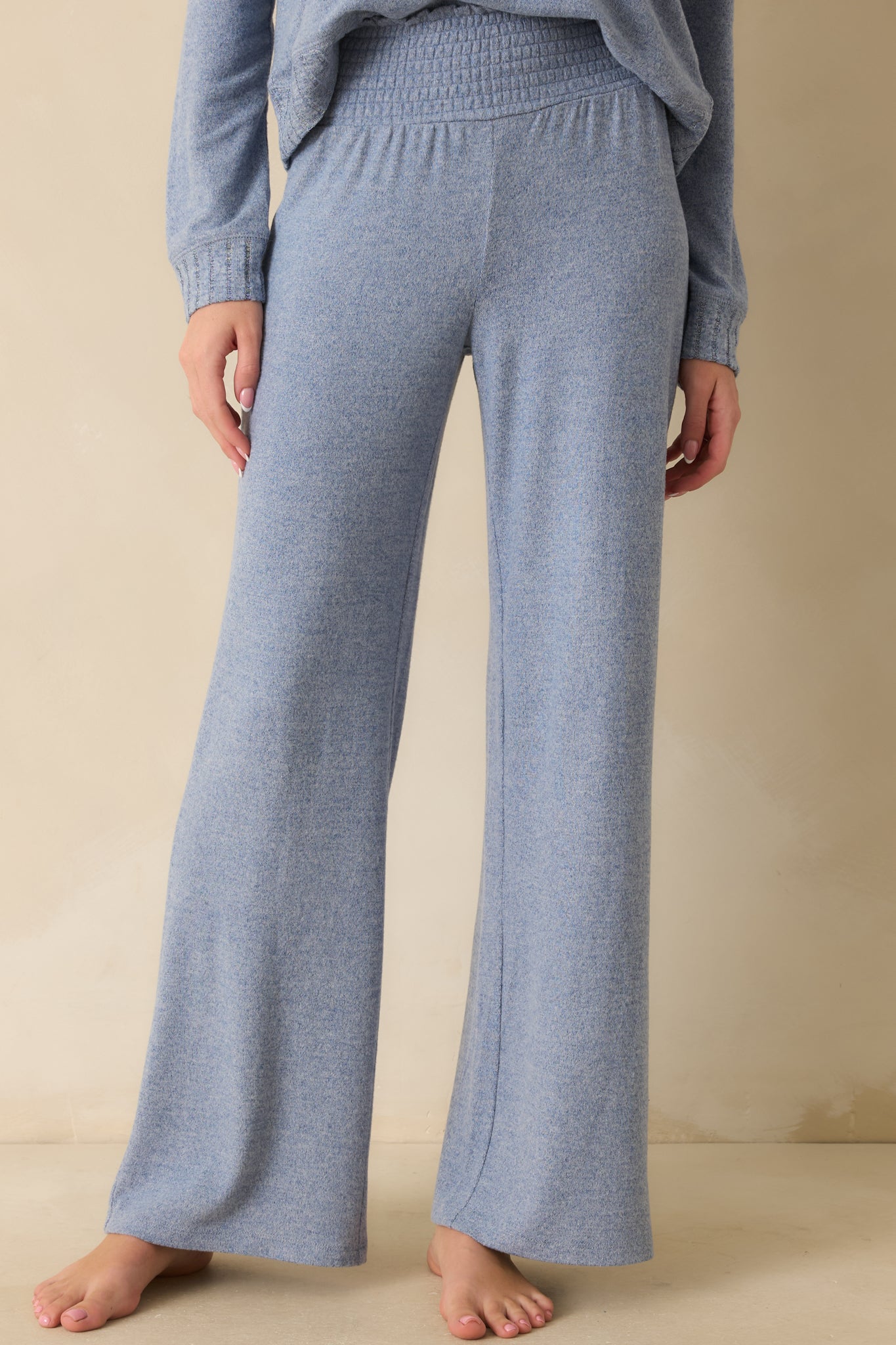 Front crop highlighting knit fabric and high-rise waist with relaxed leg silhouette.