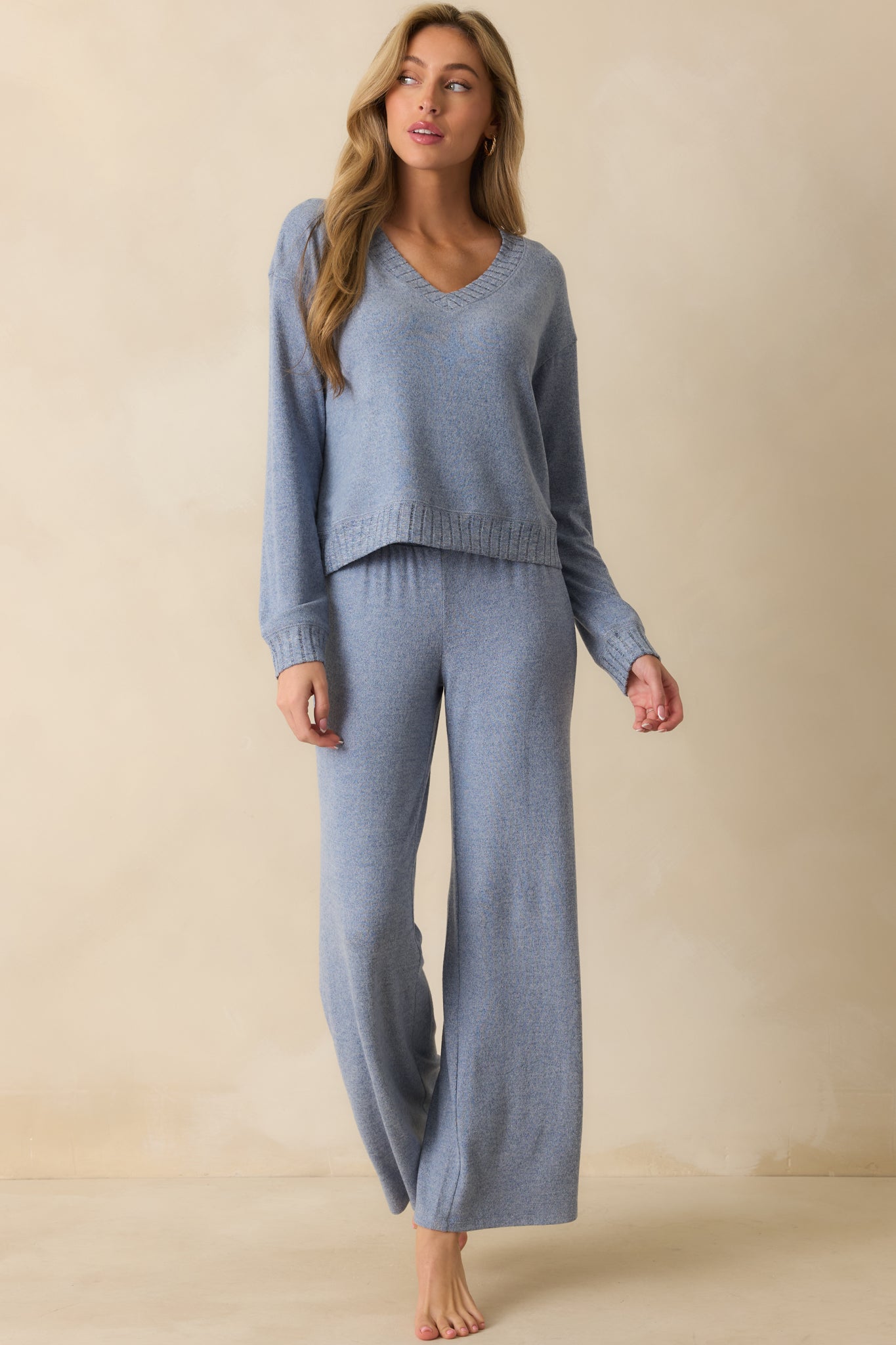 Front view of soft sweater-knit pants featuring smocked elastic waistband and flowing wide-leg cut.