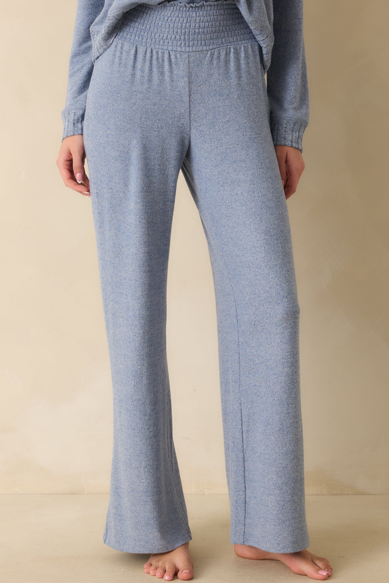 Detailed view of waistband stretch and smooth drape of the sweater-knit fabric.