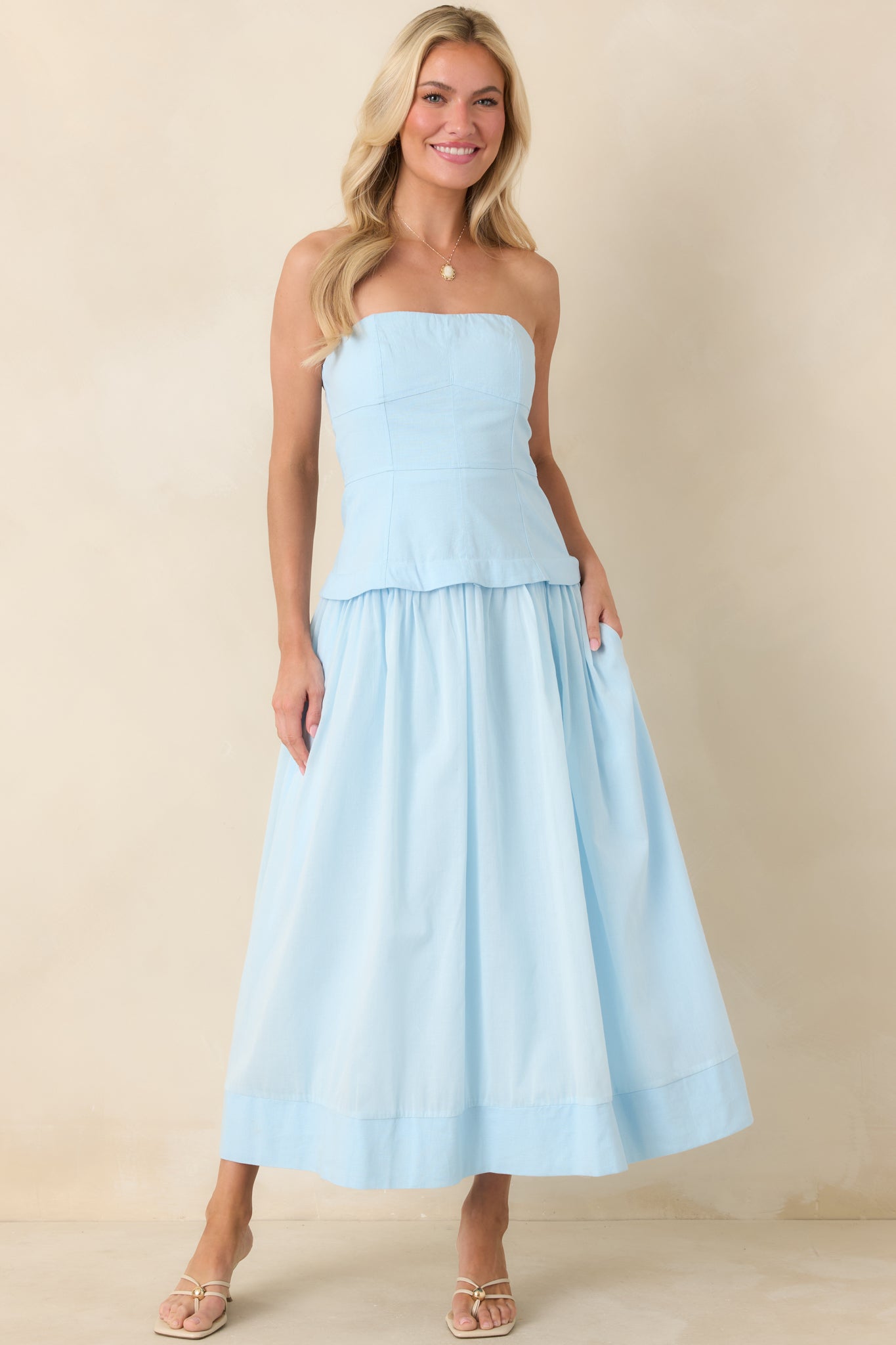 Rich blue midi featuring tailored seam paneling through the bodice and a full, flowy skirt designed for graceful movement.