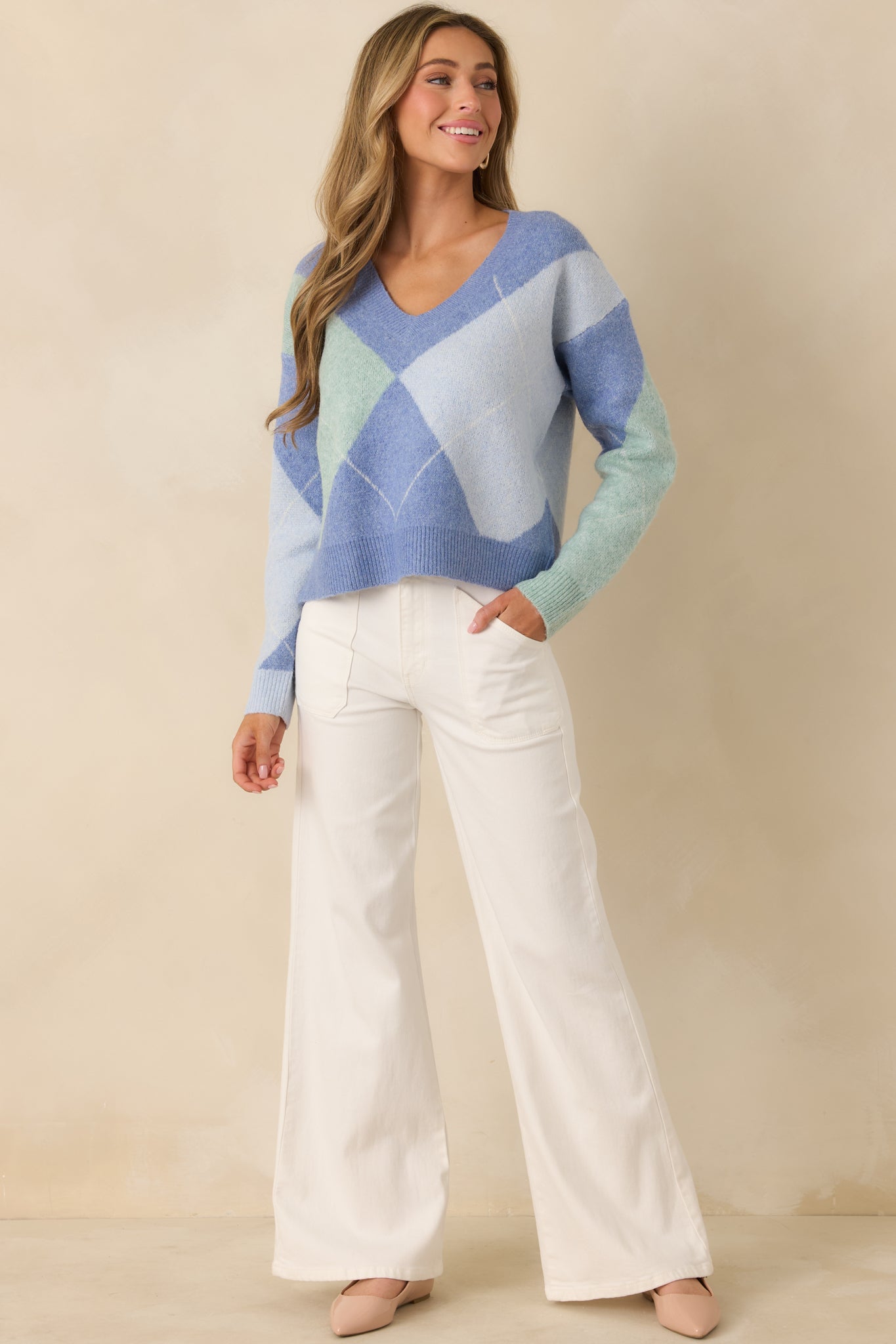 Full front view of blue multi-knit sweater with argyle pattern and V-neckline.
