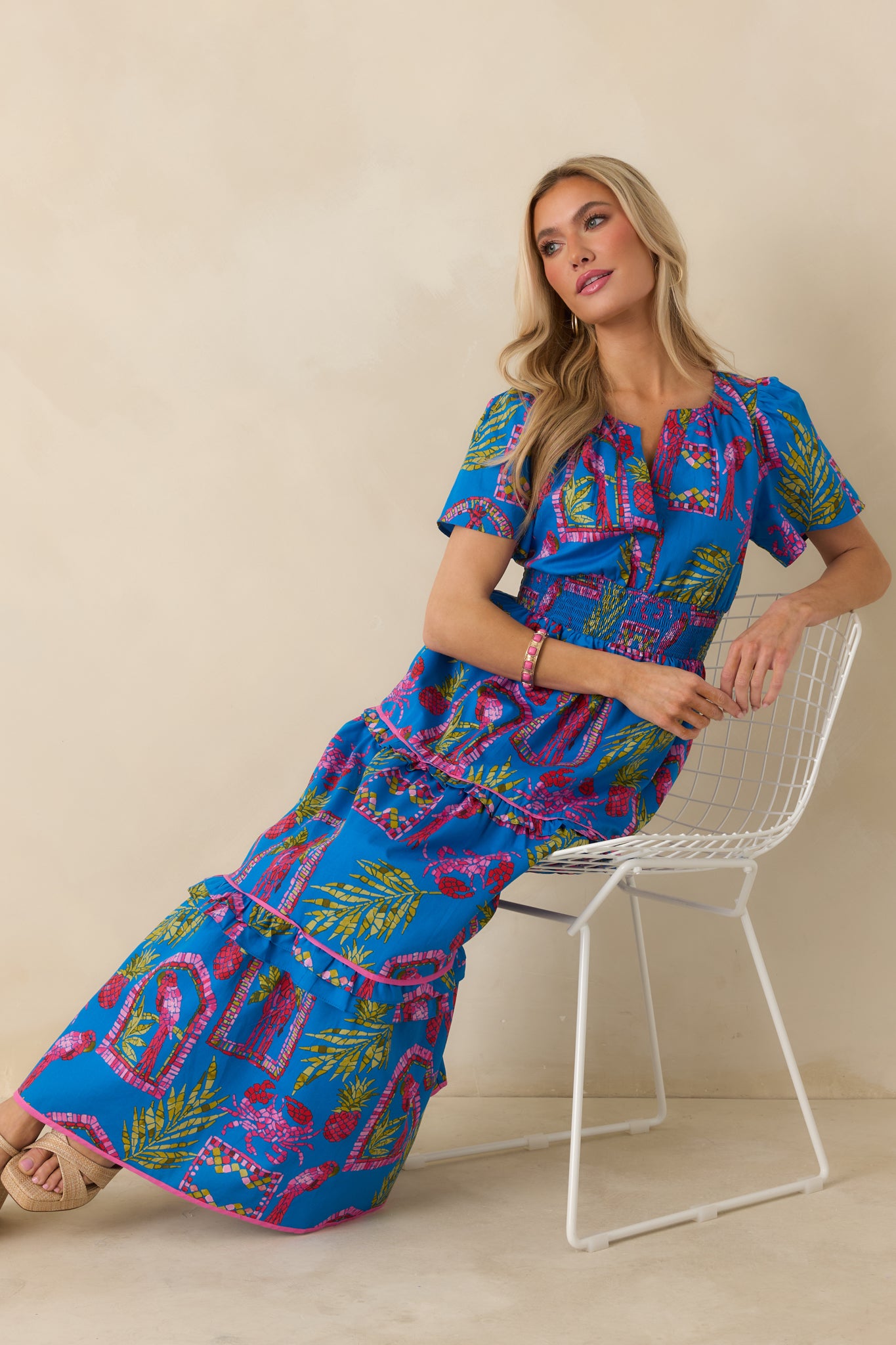 Blue multi maxi dress featuring a tropical mosaic print, split V-neckline, and short puff sleeves.