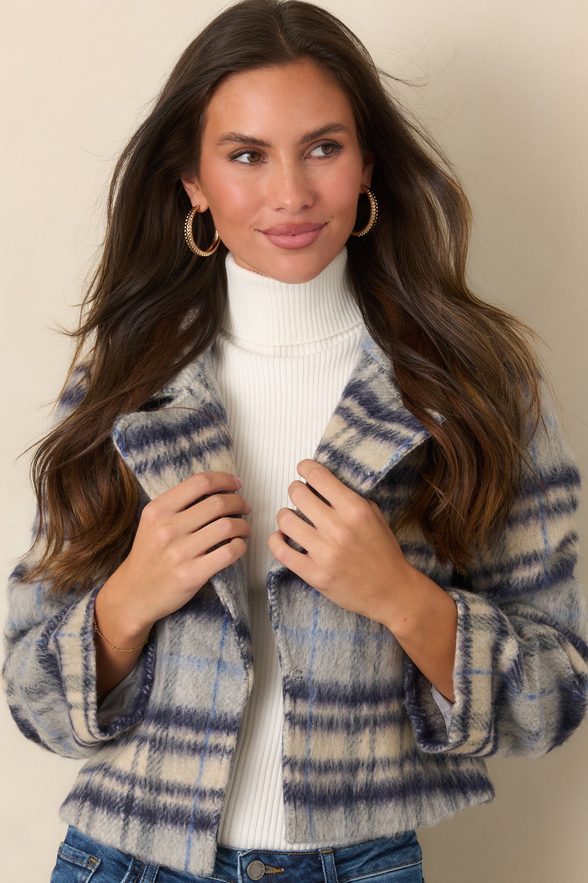 Plaid jacket with a blue, navy, and ivory pattern, relaxed sleeves, and wide folded cuffs.