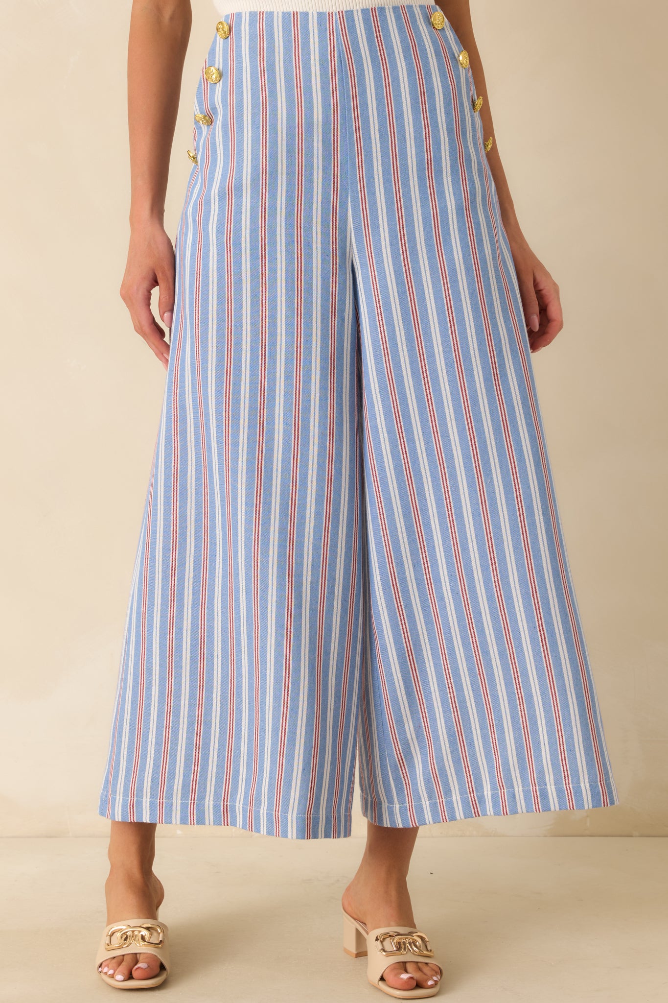 Blue, red, and ivory striped cropped pants featuring a flattering fitted waist and wide leg silhouette with fluid movement.