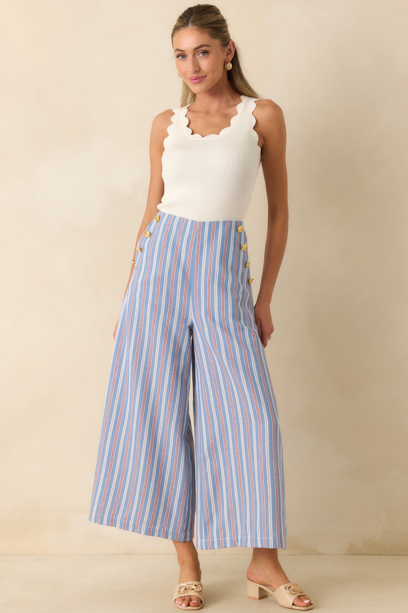 Blue, red, and ivory striped high-rise pants featuring a cropped wide leg silhouette, sailor-inspired gold-tone buttons, and a polished tailored fit.