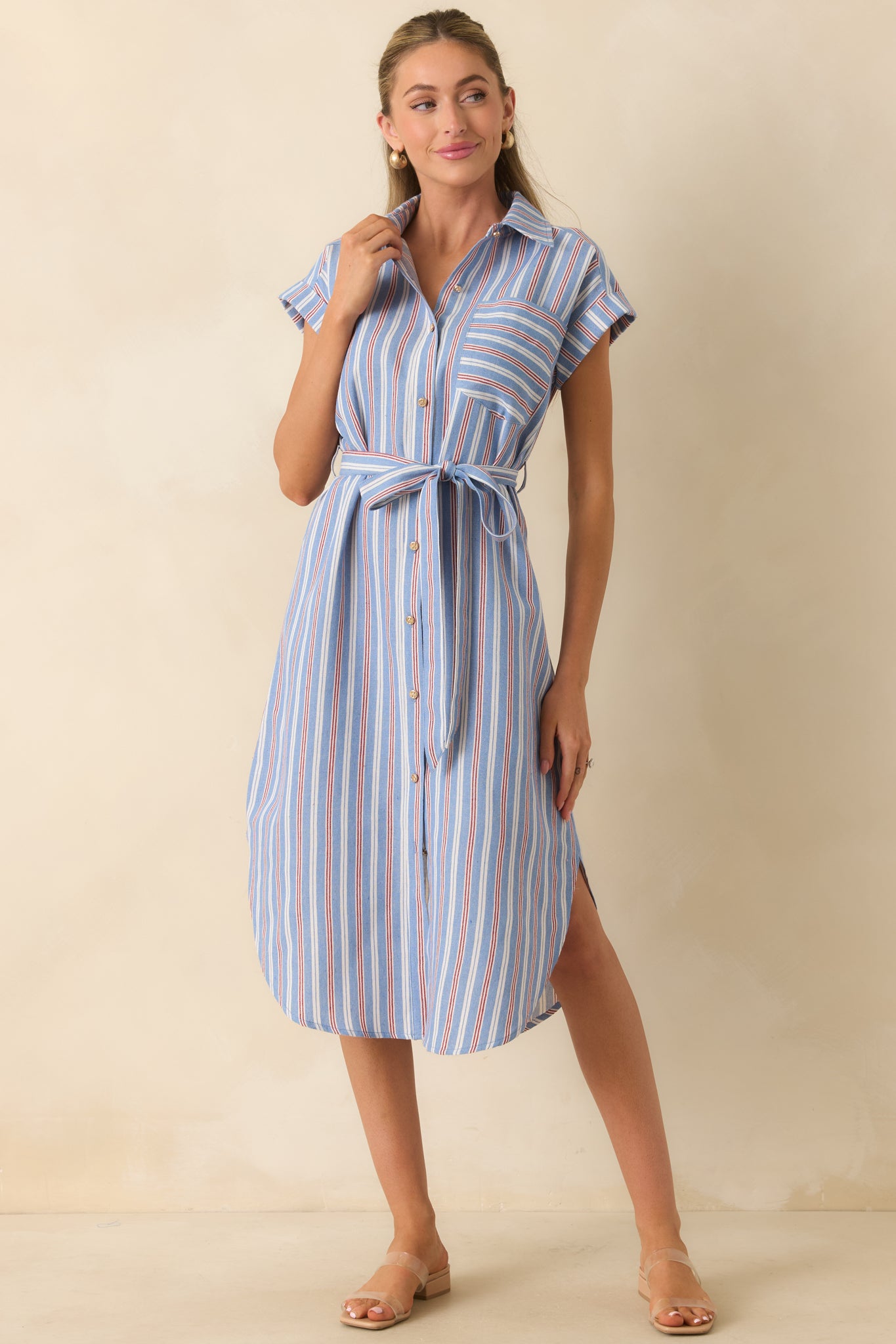 Blue, red, and ivory striped midi dress featuring a collared neckline, gold-tone button-front closure, cap sleeves, and a coordinating self-tie belt.