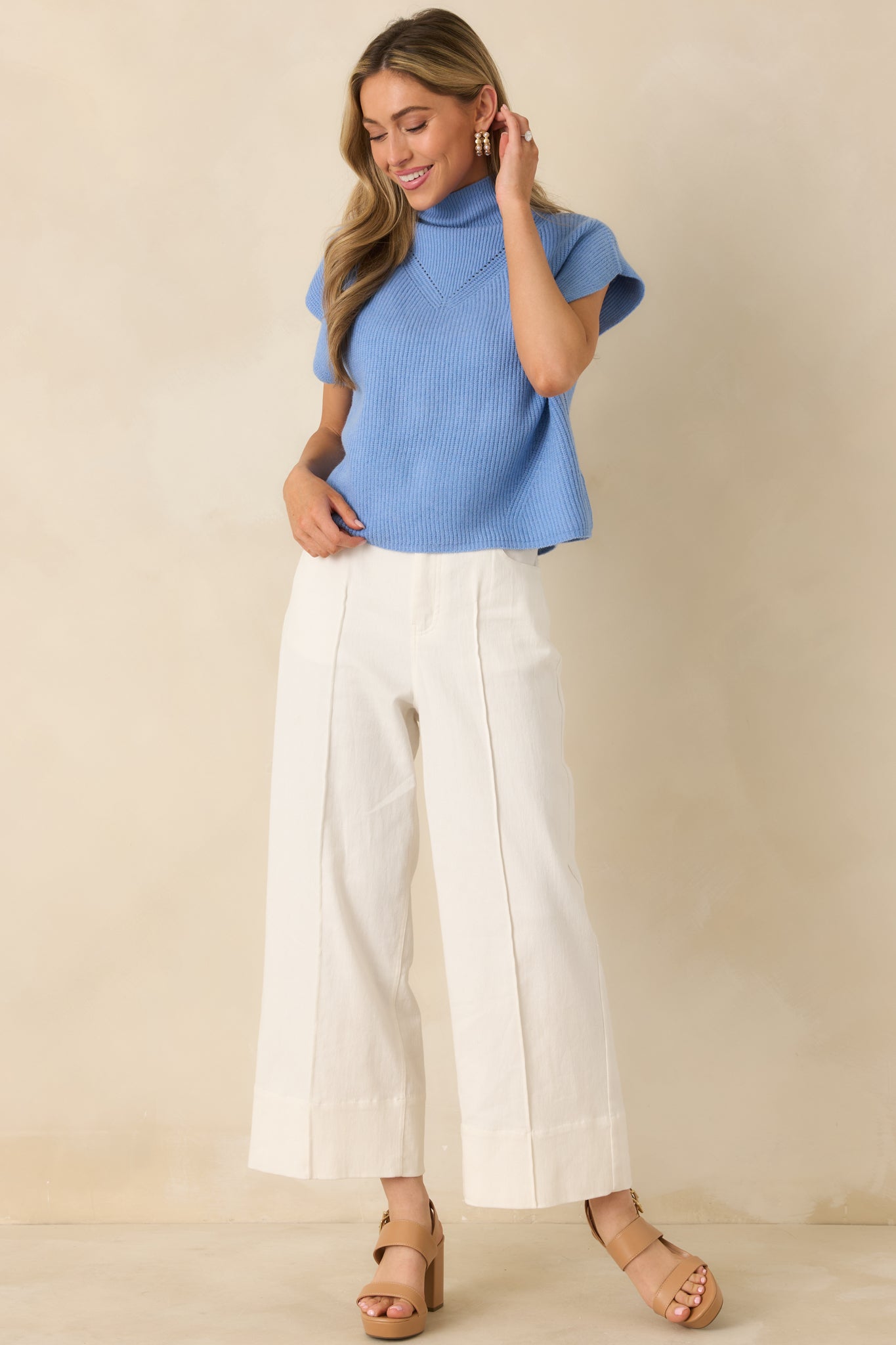 Blue ribbed knit top with mock neck design and gentle vertical ribbed texture for a soft, refined finish.