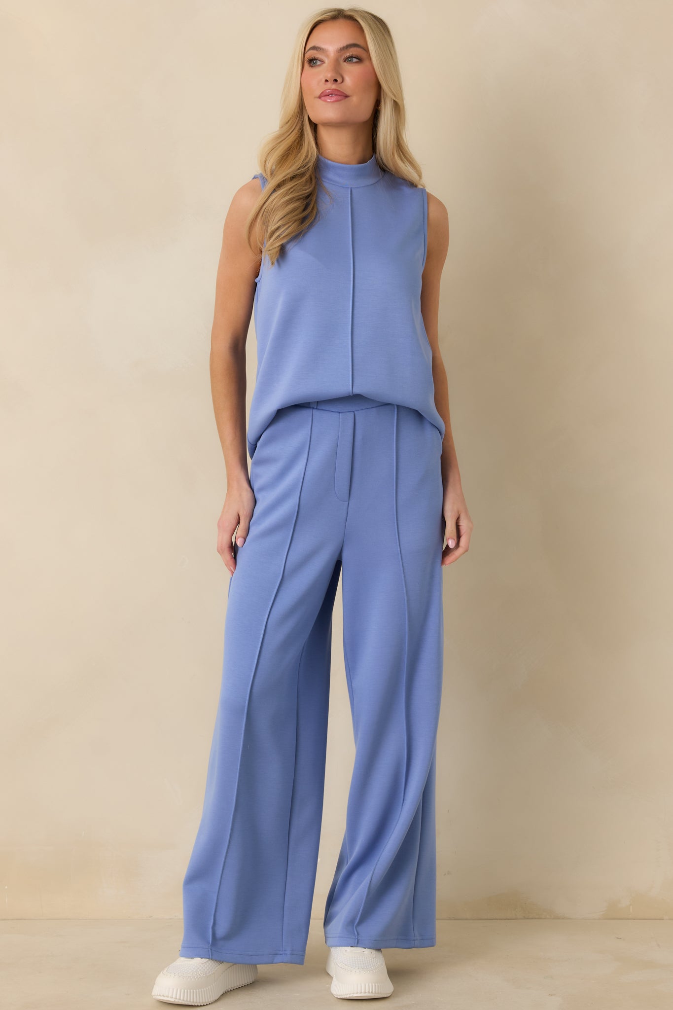 Blue sleeveless tank top with a soft mock neckline, featuring a clean center front seam and a relaxed straight silhouette.