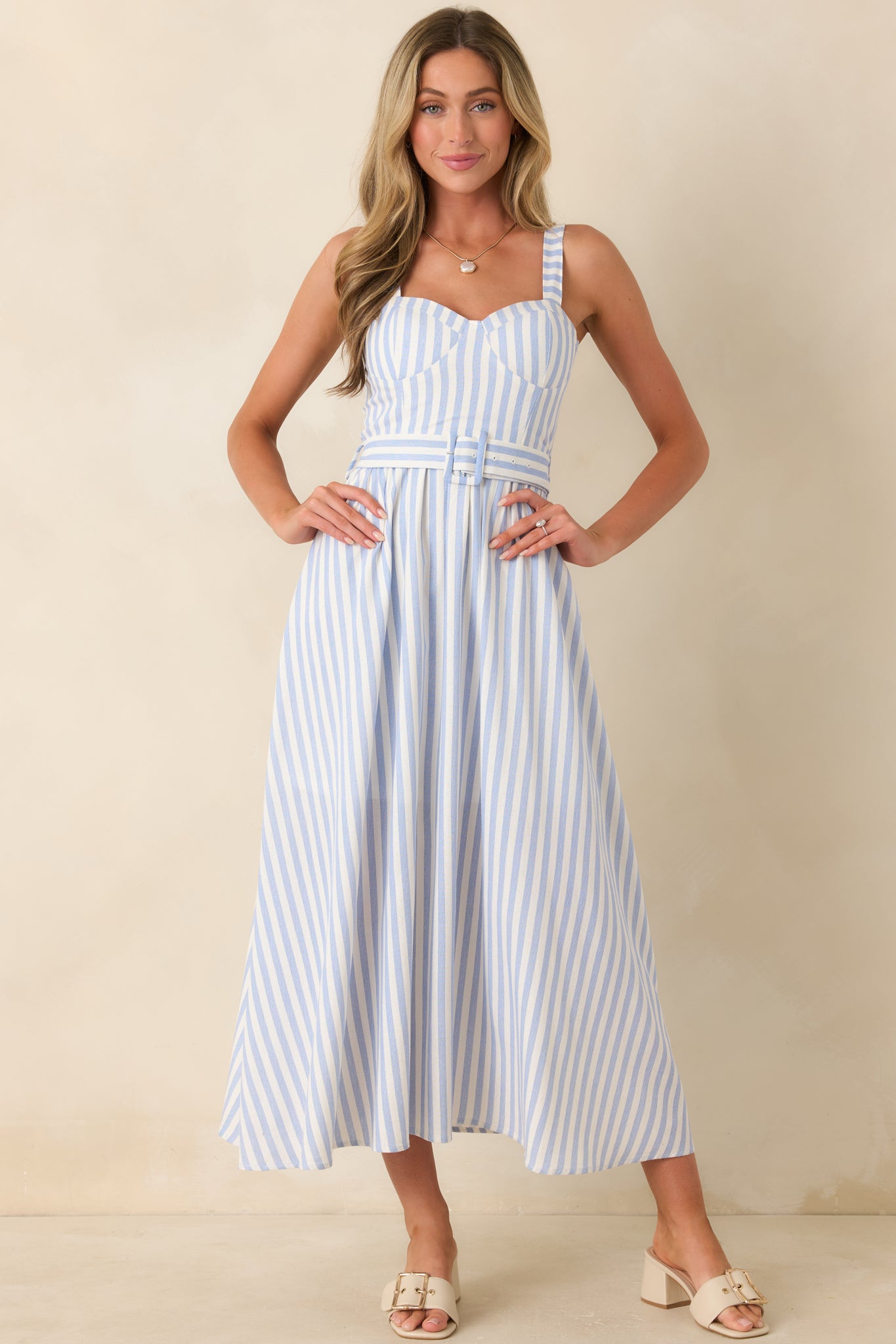 Breathable blue striped midi dress featuring a coordinating fabric belt and an effortless warm-weather silhouette.