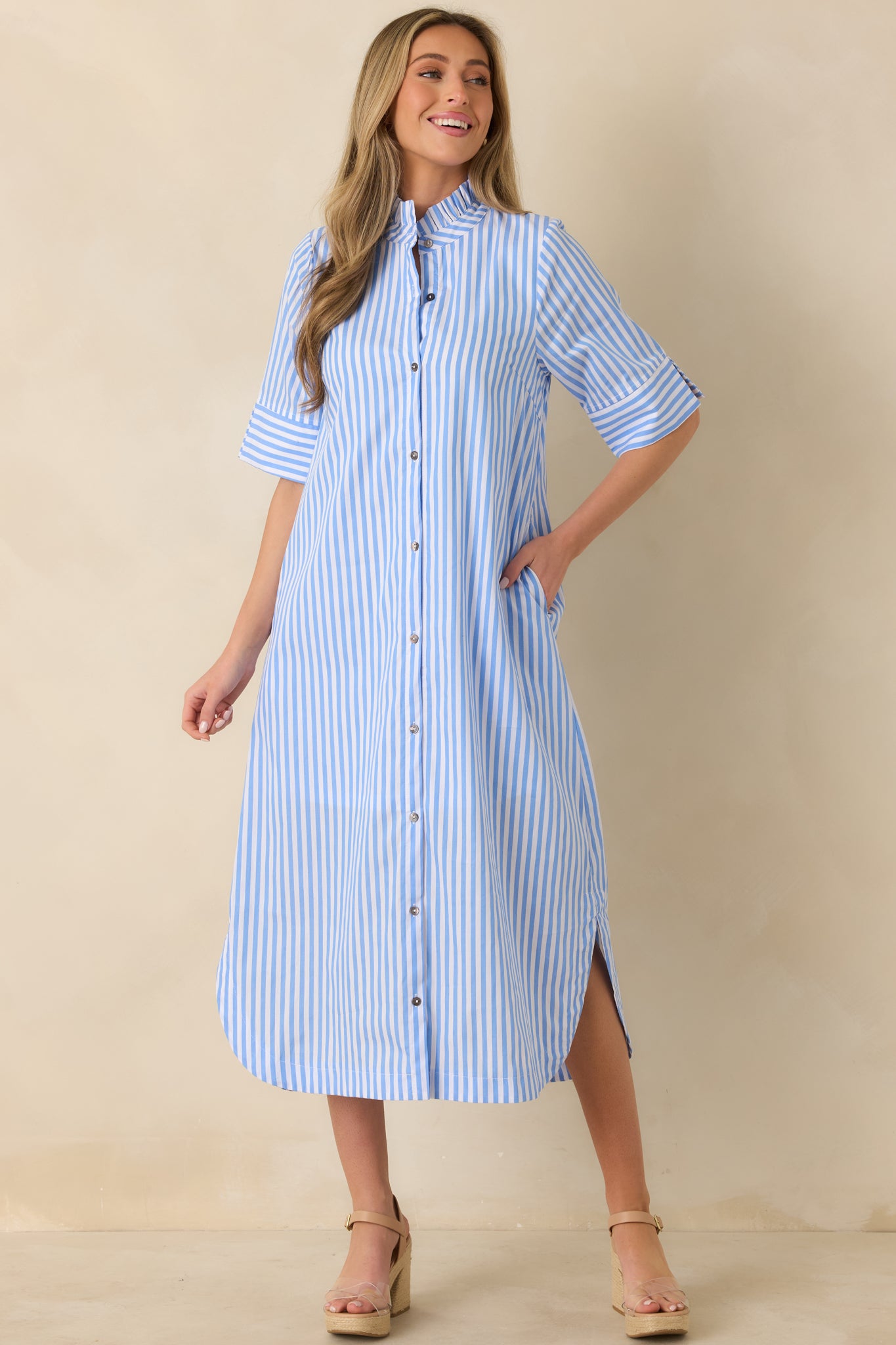 Blue striped midi dress highlighting the shirttail hemline and easy, flattering silhouette.
