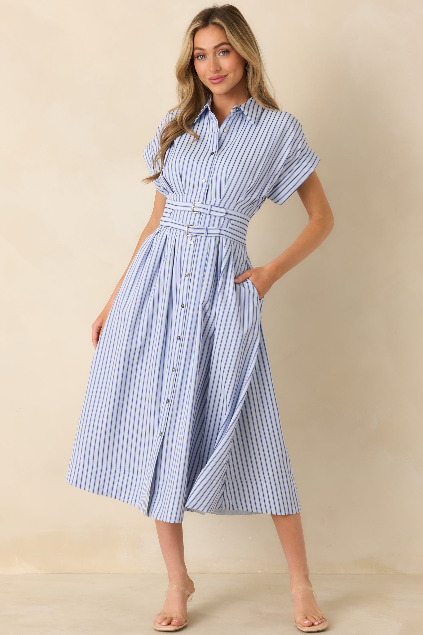 Blue midi dress with dark and light blue vertical stripes, a collared neckline, and a functional button-front closure.