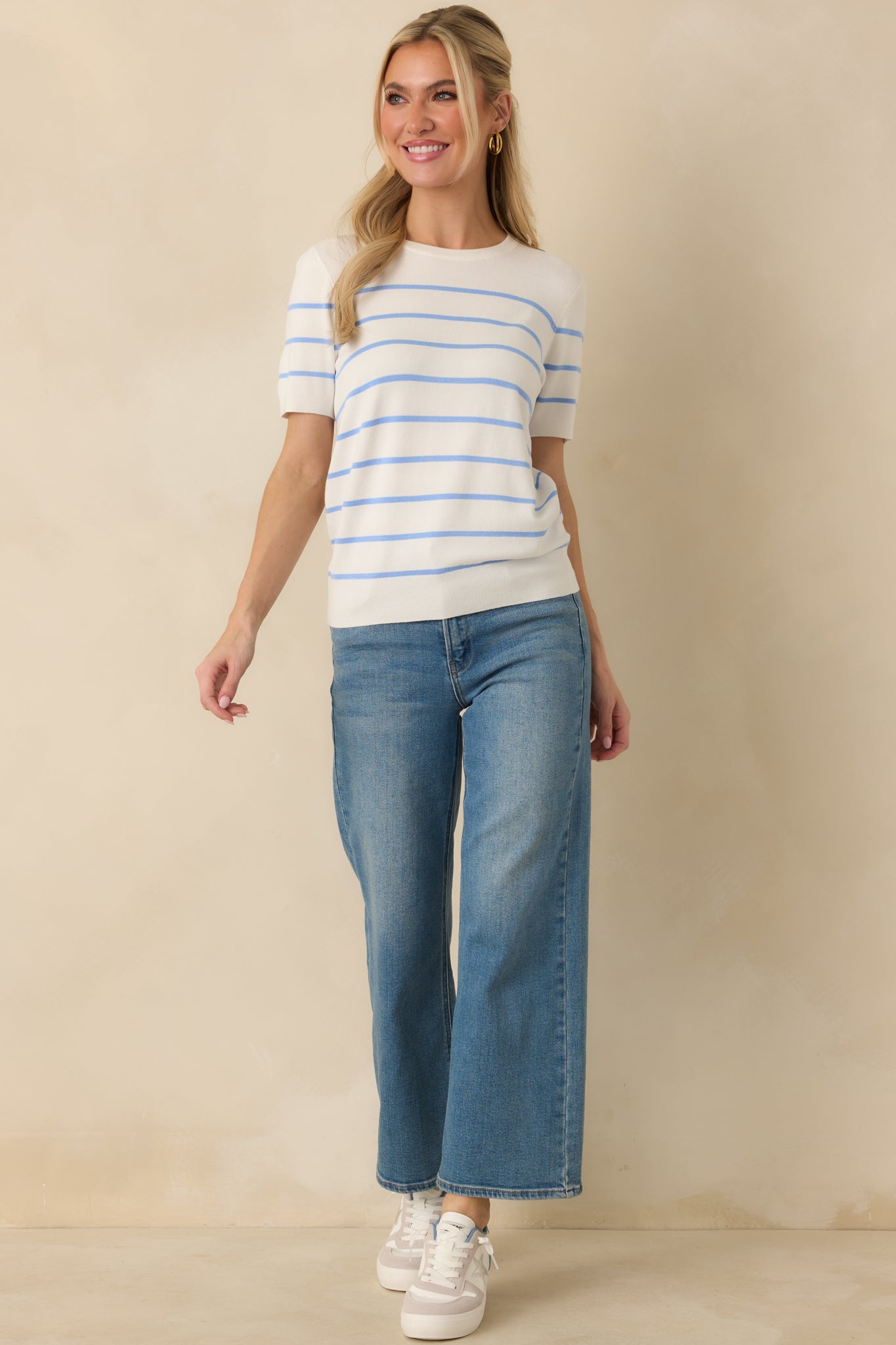 Blue striped short sleeve knit sweater featuring a round neckline and lightweight fine-gauge construction.