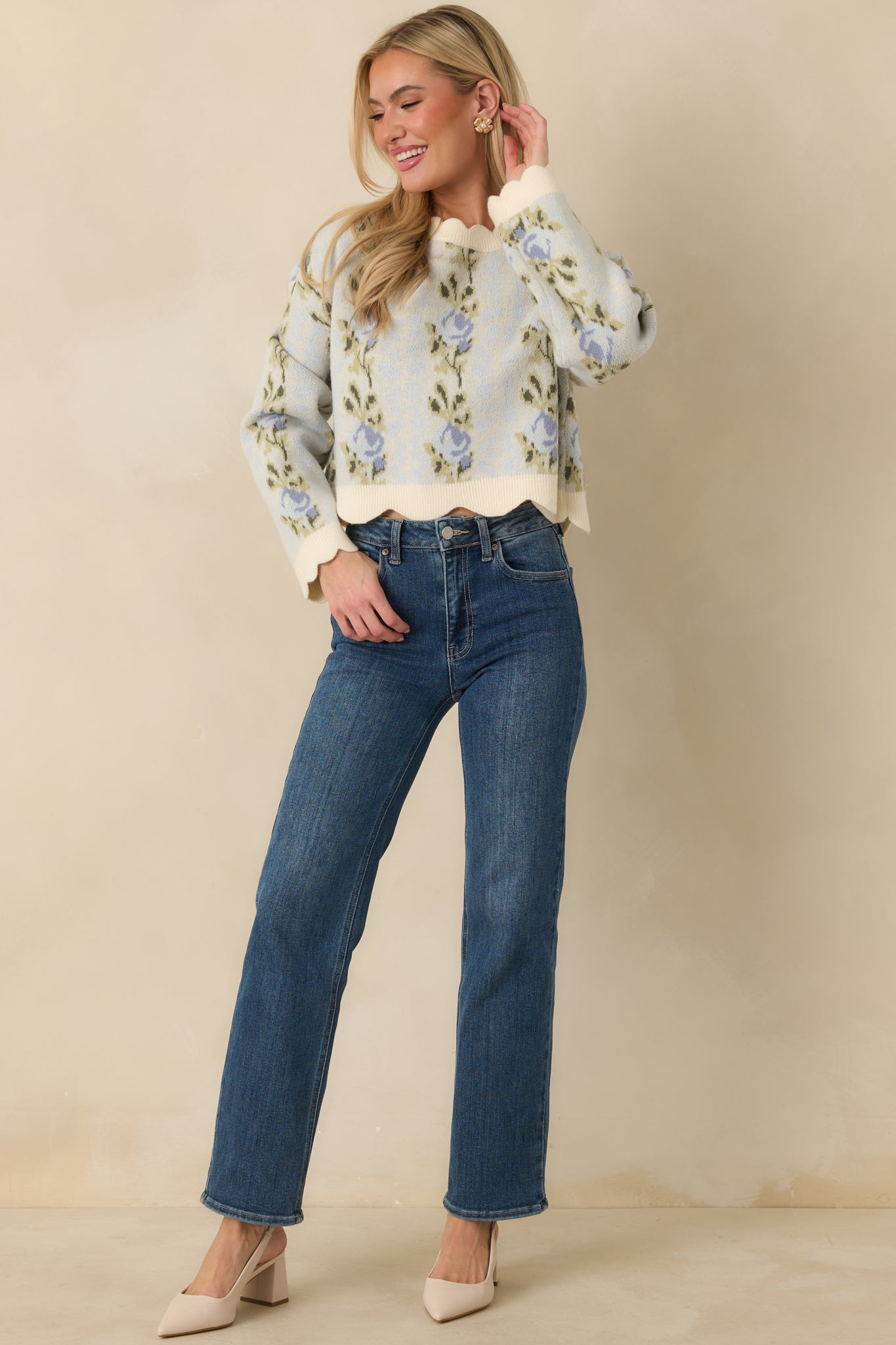 Blue sweater with ribbed trim, round neckline, and subtly cropped length in a cozy knit.