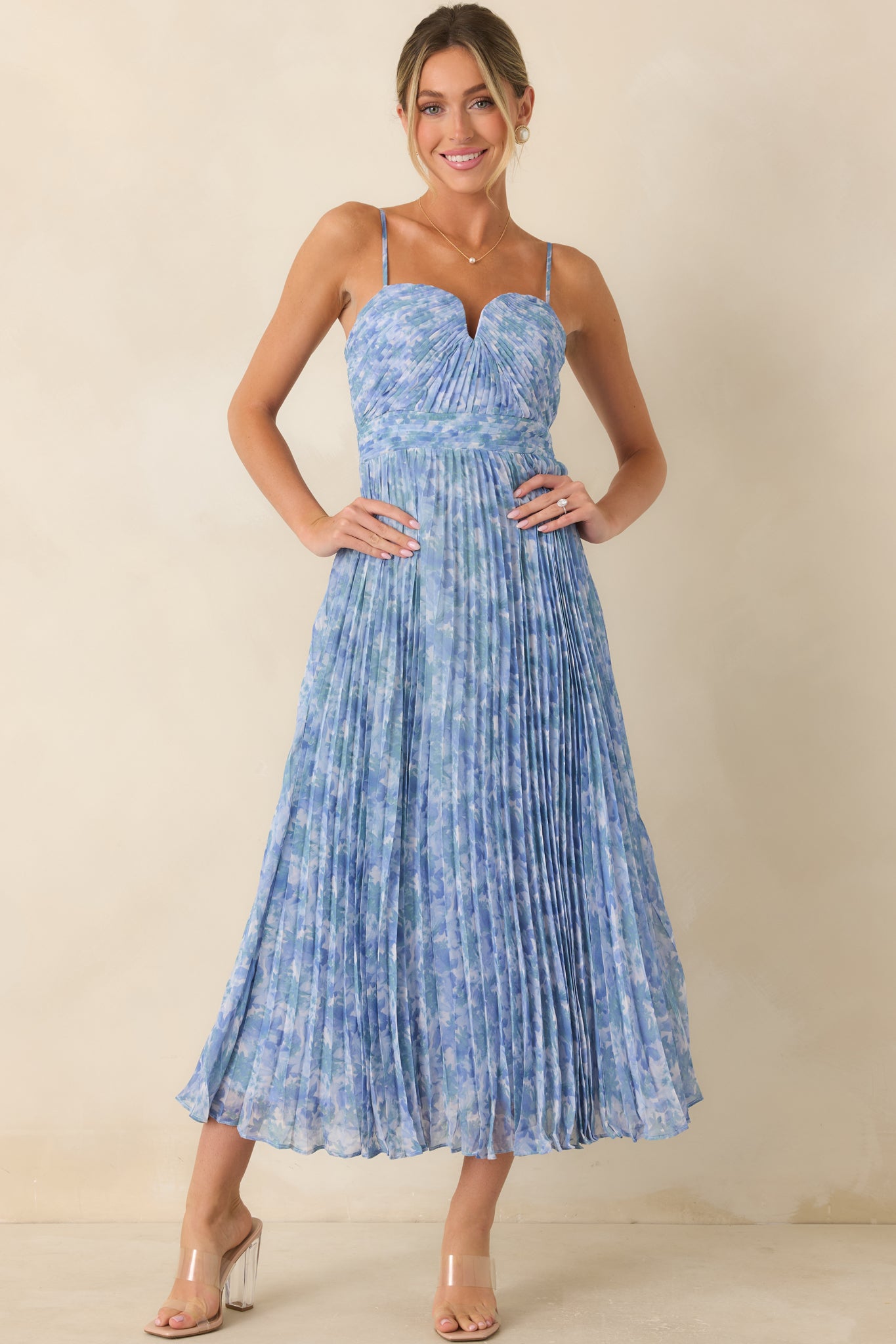 Maxi dress showcasing a soft blue floral print, structured fitted bodice, and graceful full-length silhouette.
