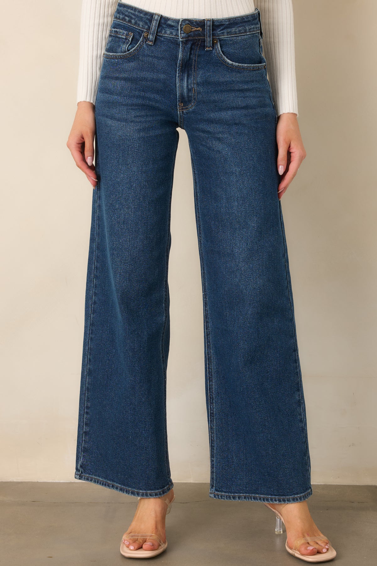 Wide leg blue jeans feature subtle fading through the thighs and a relaxed cut from hip to hem.